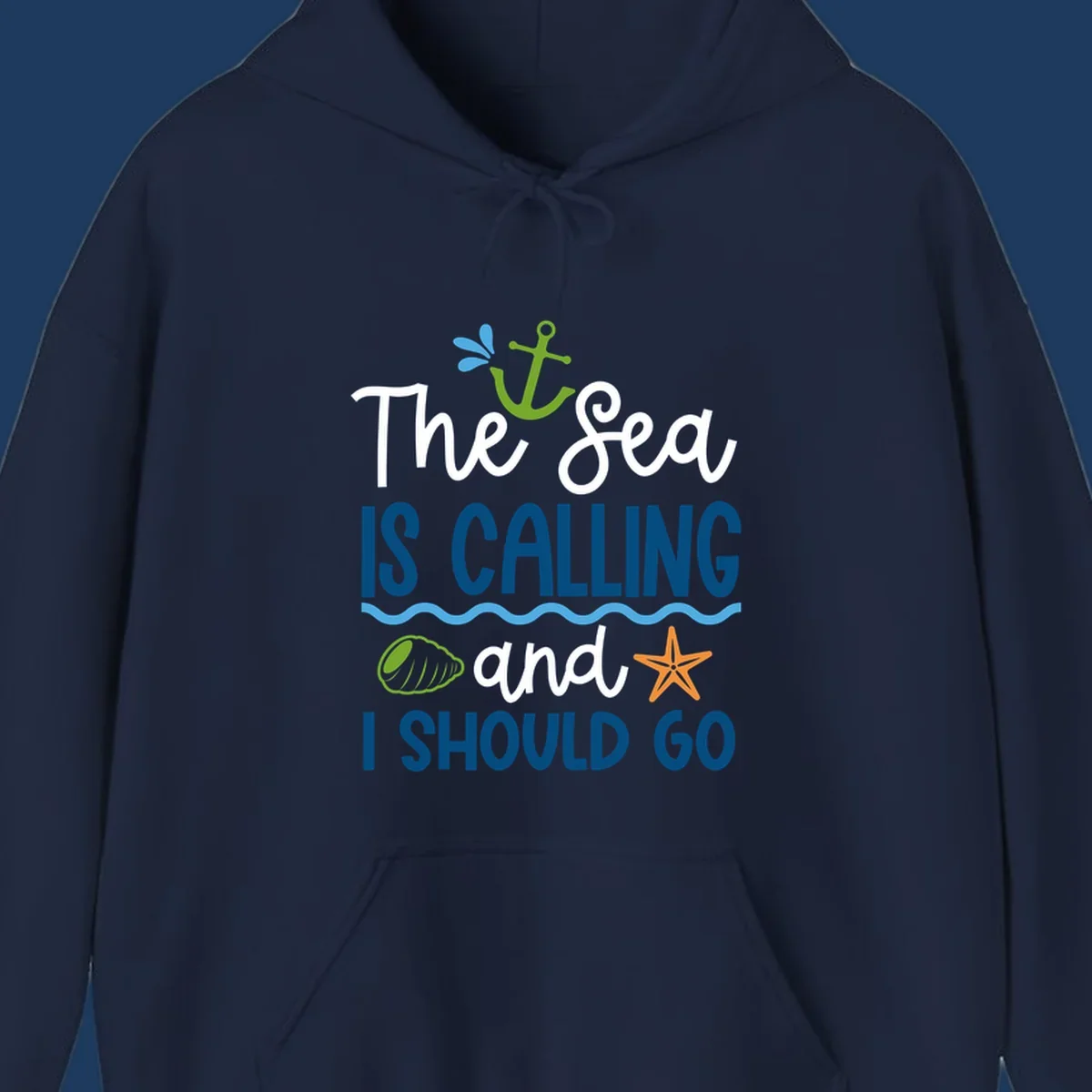 Gray tee design with 'The Sea Is Calling and I Should Go' text in white and blue, decorated with nautical icons including anchor, starfish, seashell, and ocean waves.