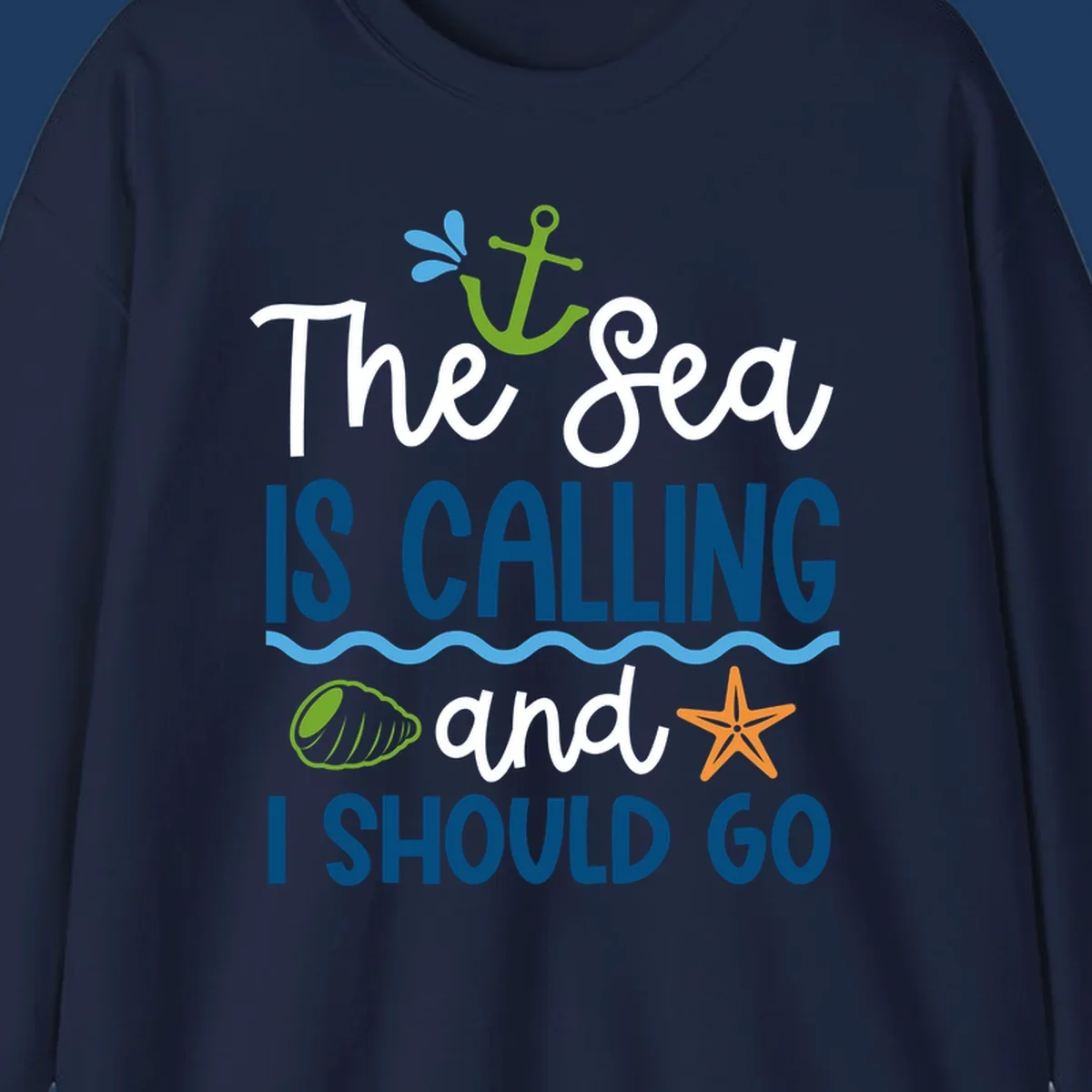 Gray tee design with 'The Sea Is Calling and I Should Go' text in white and blue, decorated with nautical icons including anchor, starfish, seashell, and ocean waves.