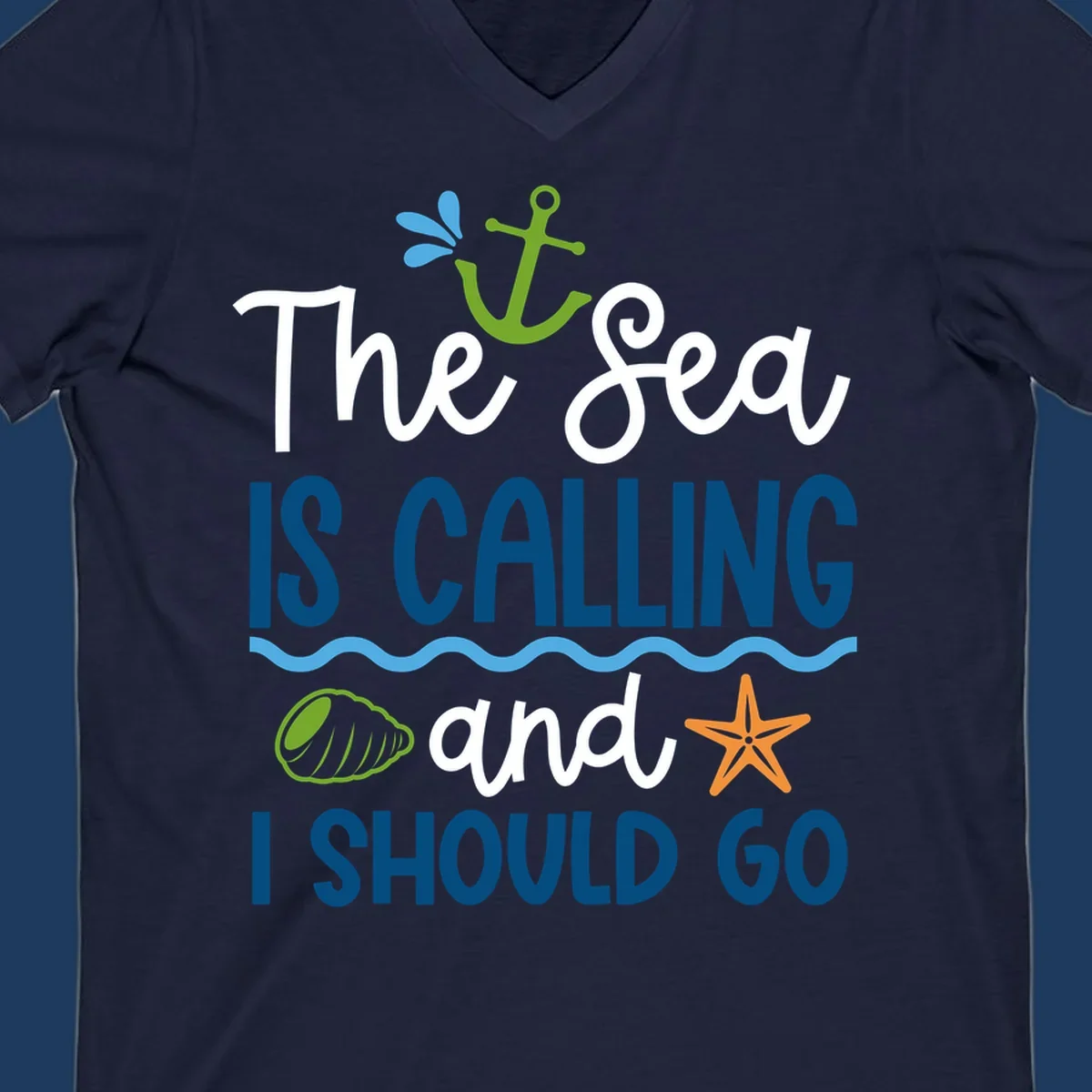 Gray tee design with 'The Sea Is Calling and I Should Go' text in white and blue, decorated with nautical icons including anchor, starfish, seashell, and ocean waves.