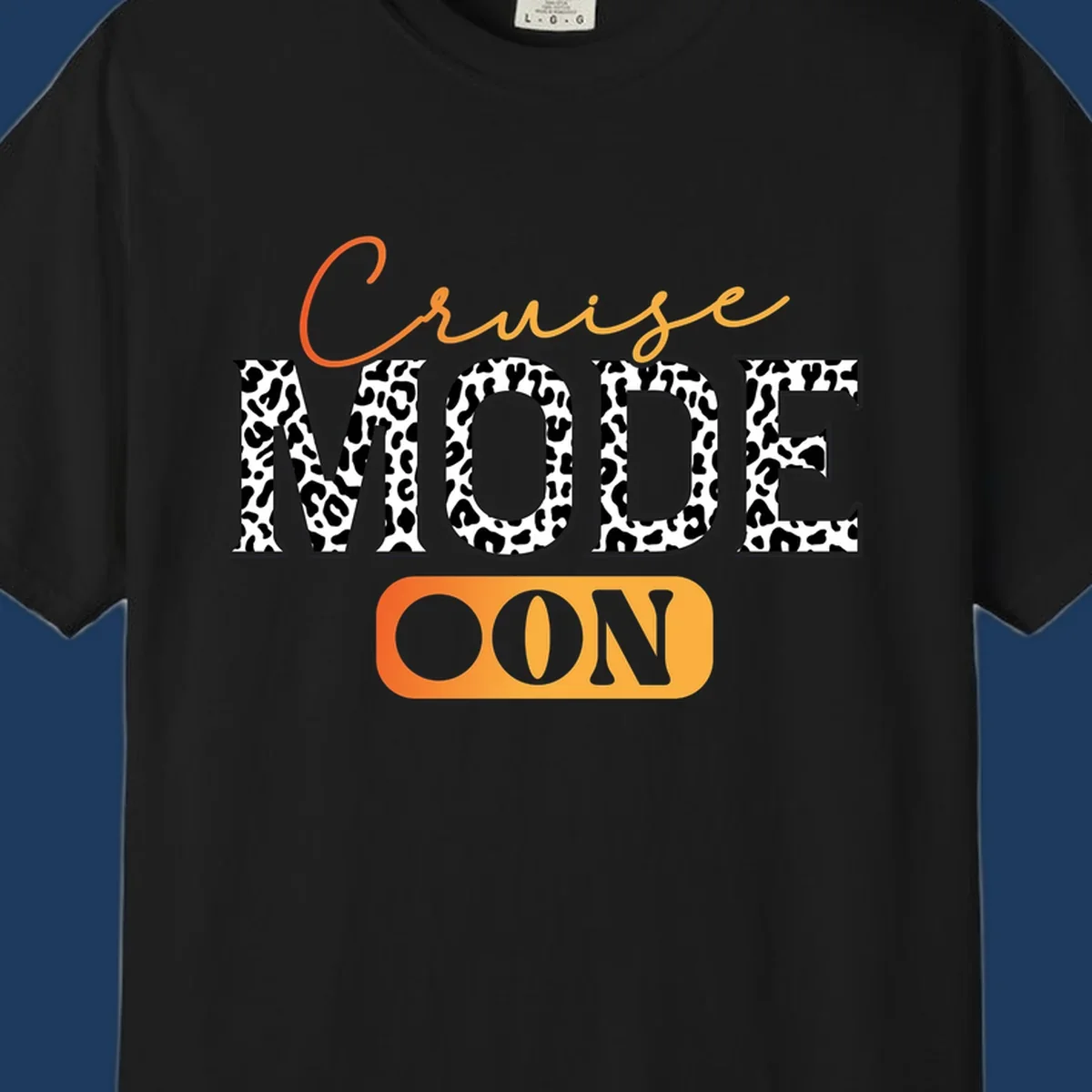 Cruise mode on design with orange cursive text and leopard print letters on gray background