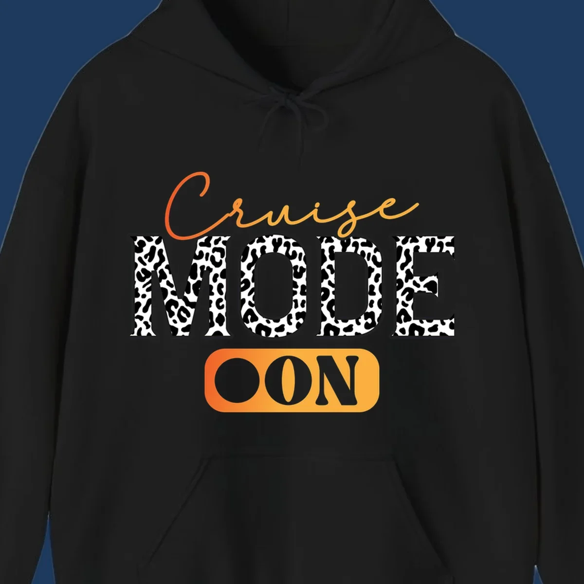 Cruise mode on design with orange cursive text and leopard print letters on gray background