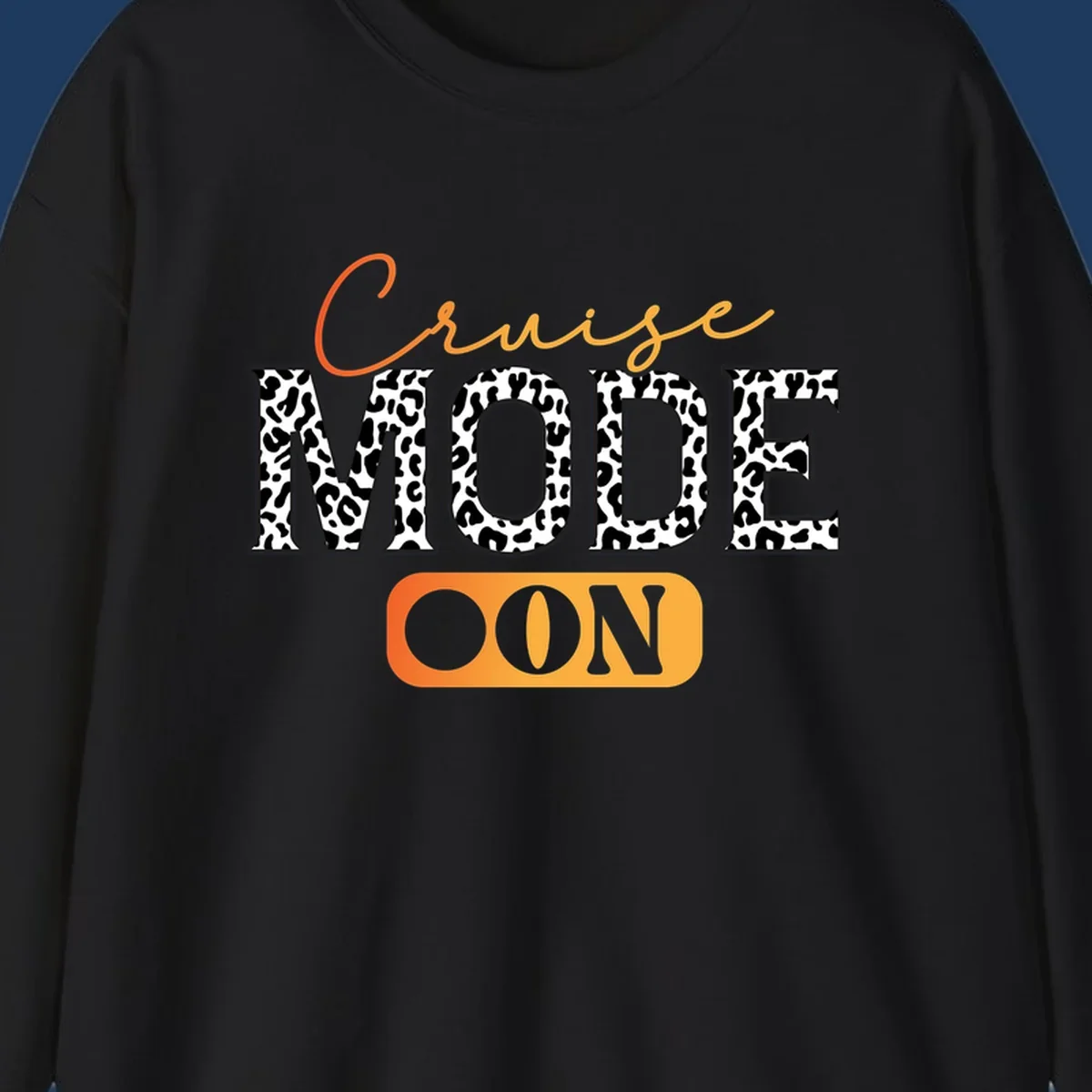 Cruise mode on design with orange cursive text and leopard print letters on gray background