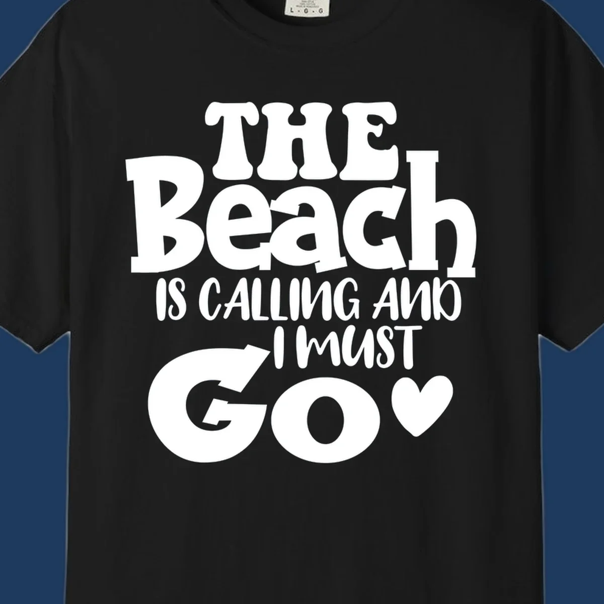 Beach is calling and I must go typography design with heart symbol, white text on gray background