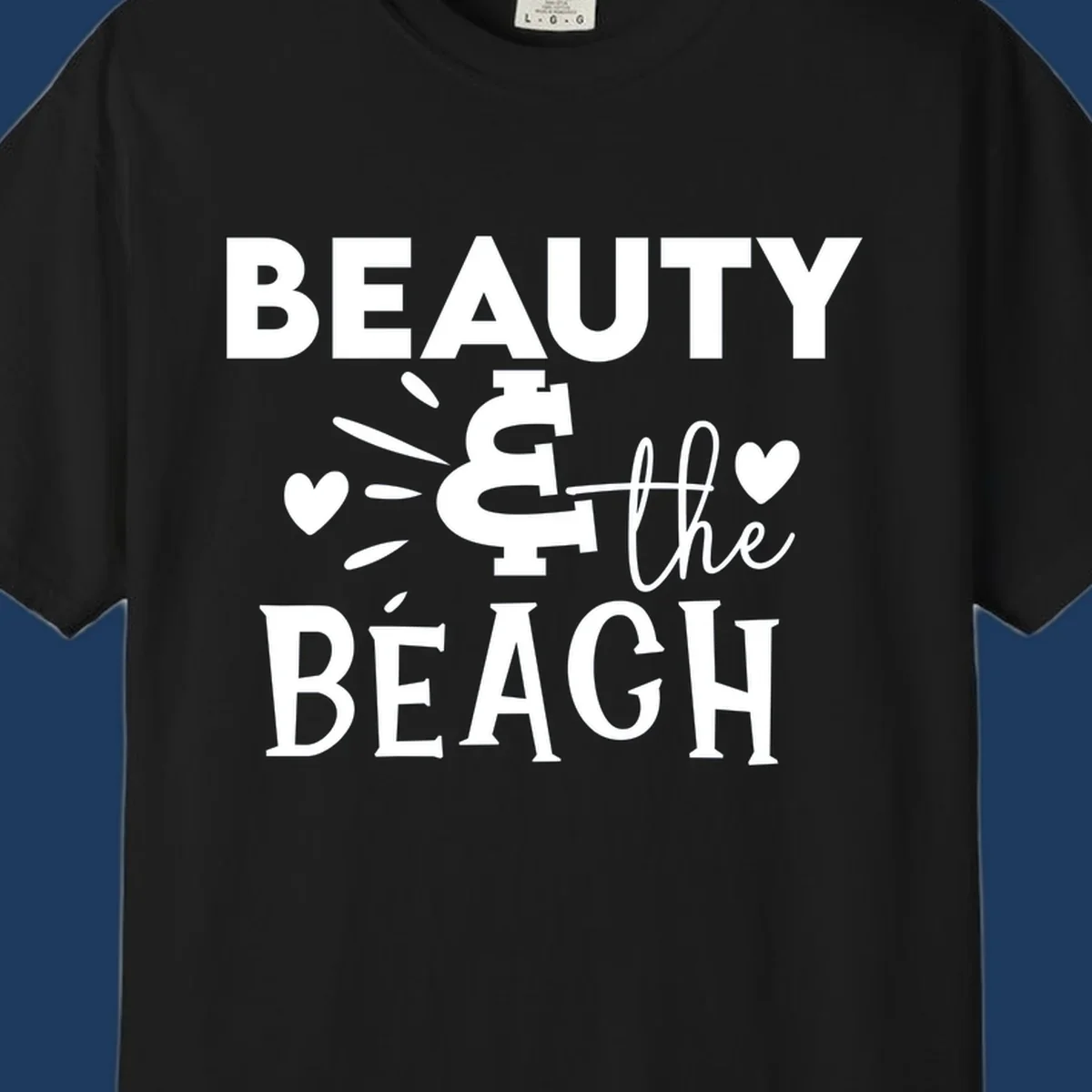 White text design reading 'Beauty & The Beach' with dollar sign symbol and heart decorations on gray background