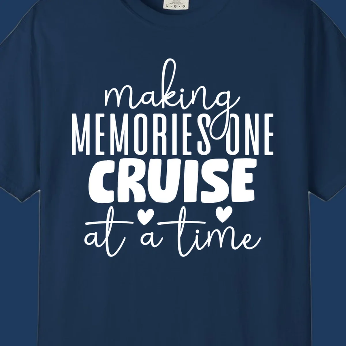 White text on gray background reading 'Making Memories One Cruise At A Time' with decorative hearts and flourishes for cruise vacation apparel