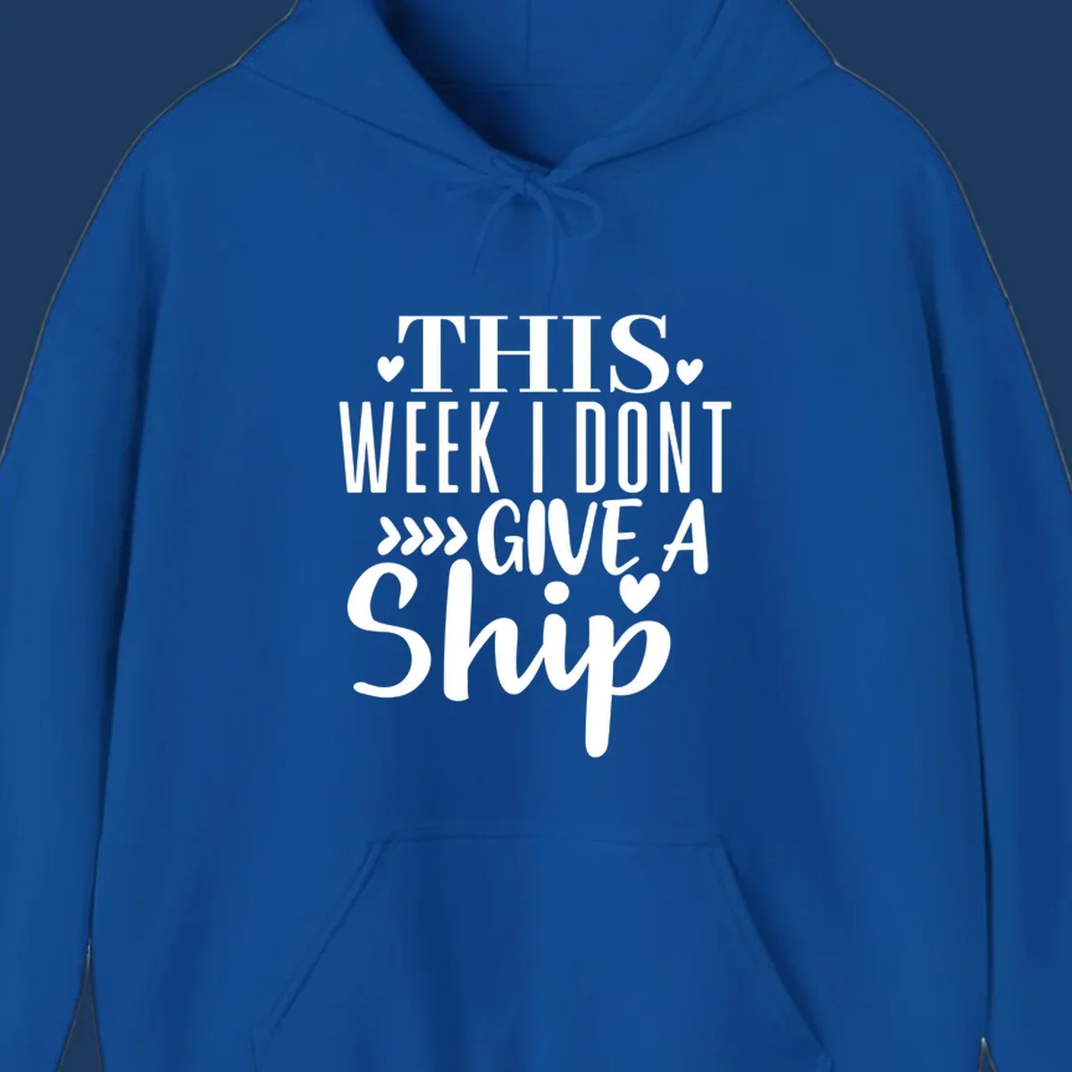 White text on gray background reading 'This Week I Don't Give A Ship' with hearts and arrows, a playful cruise humor design