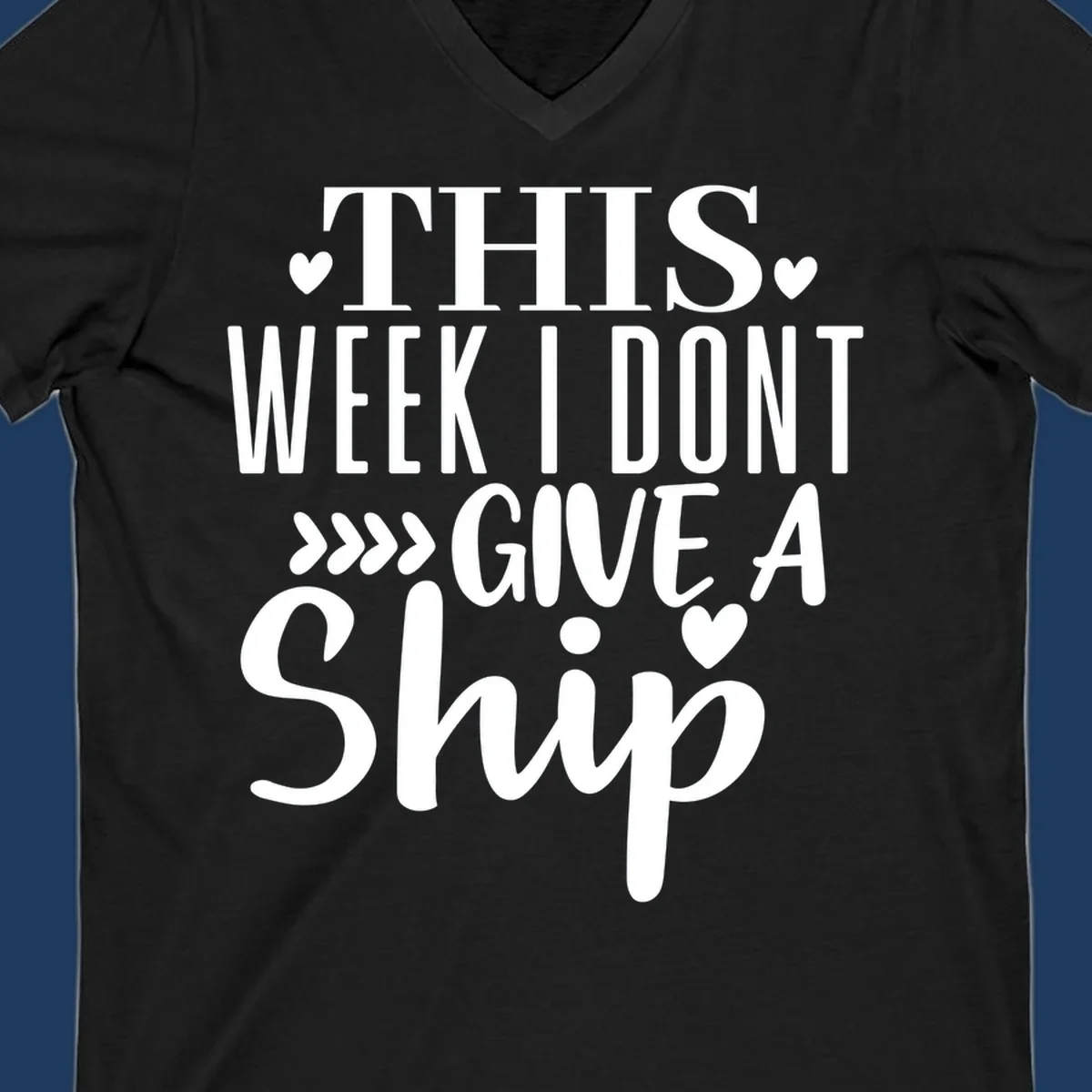 White text on gray background reading 'This Week I Don't Give A Ship' with hearts and arrows, a playful cruise humor design