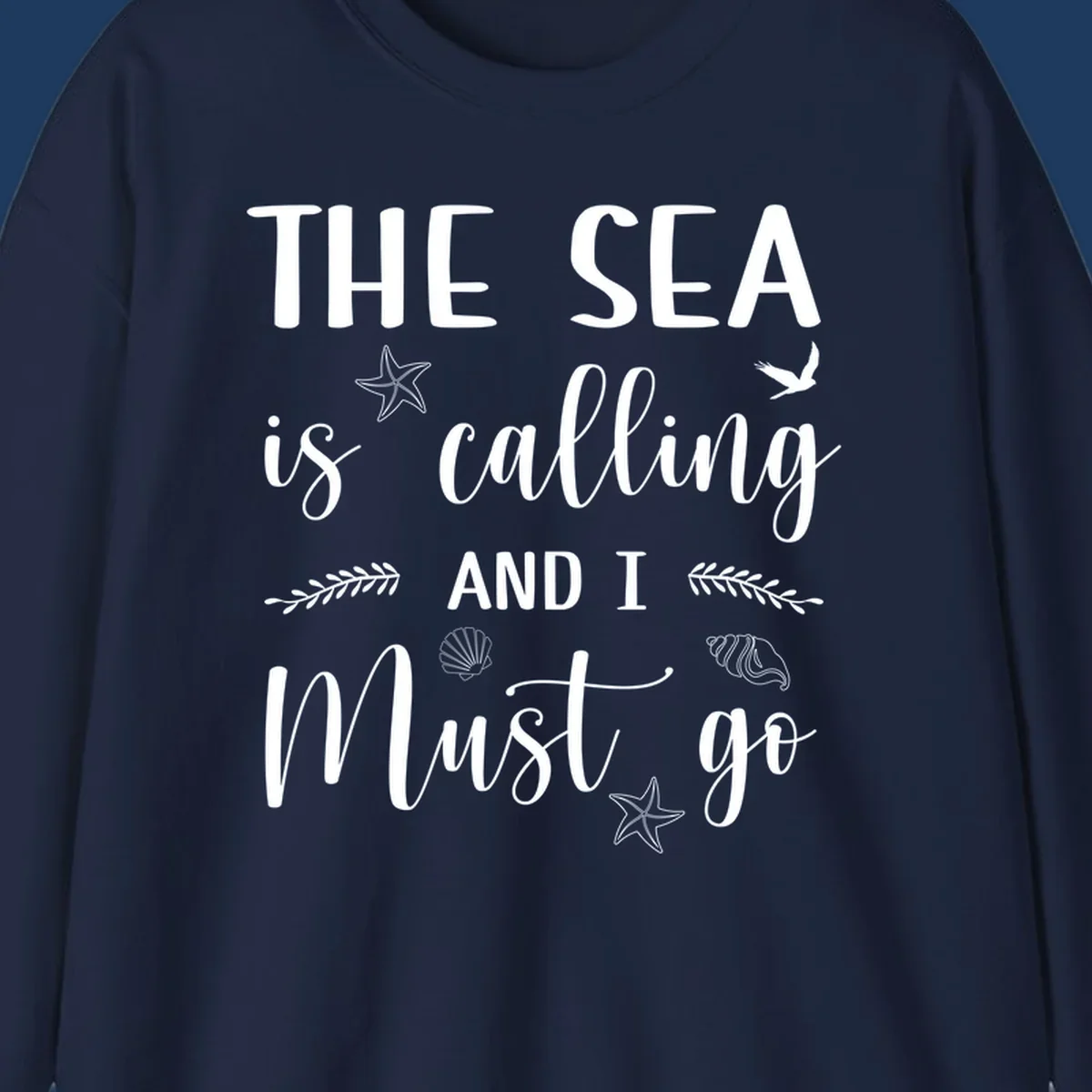 Gray design with white text reading 'The Sea is calling AND I MUST go' surrounded by starfish, seashells, a flying bird, and leaf accents