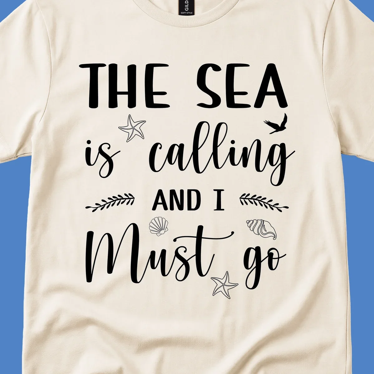 Gray design with white text reading 'The Sea is calling AND I MUST go' surrounded by starfish, seashells, a flying bird, and leaf accents