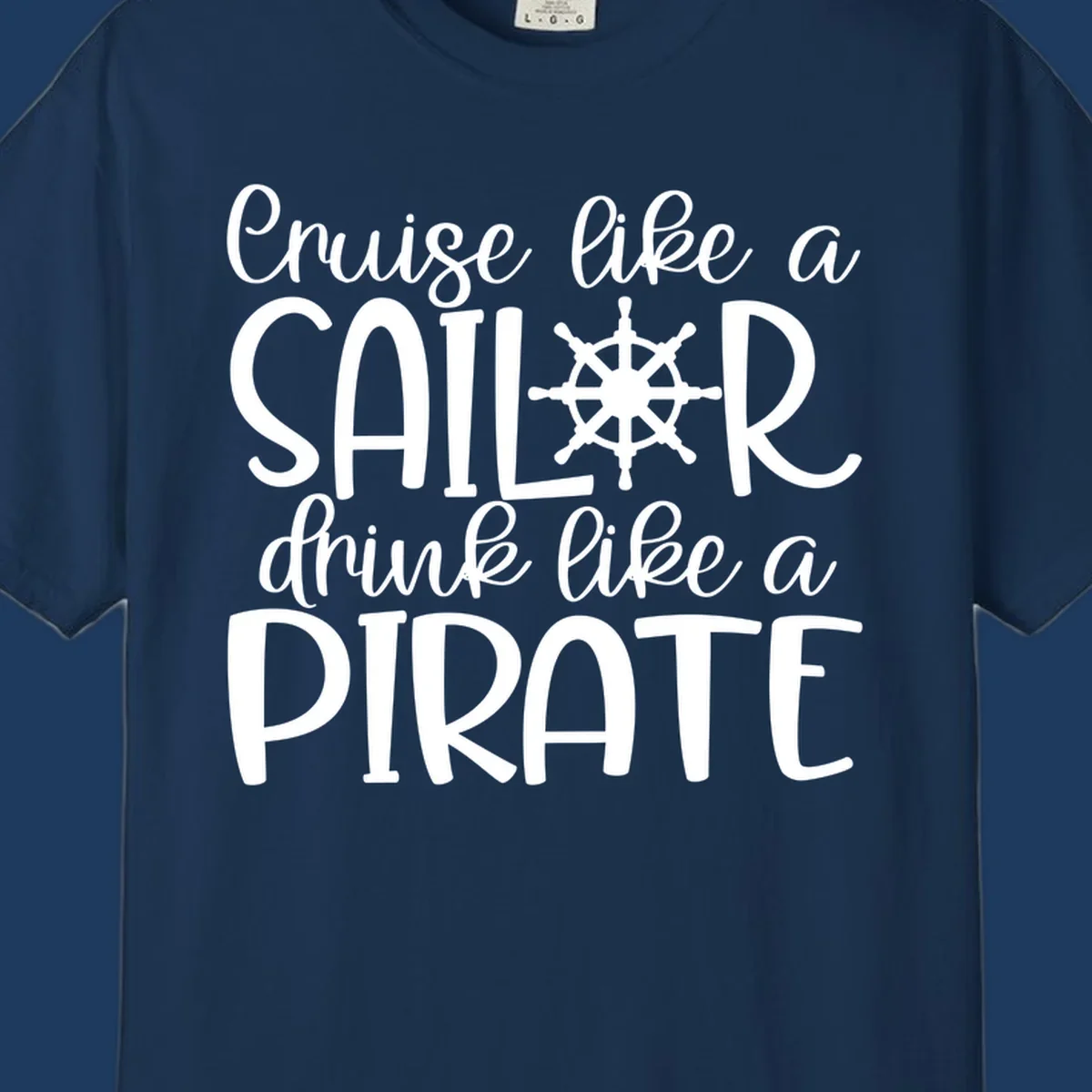 White text design with ship wheel graphic reading 'Cruise like a SAILOR drink like a PIRATE' on gray background