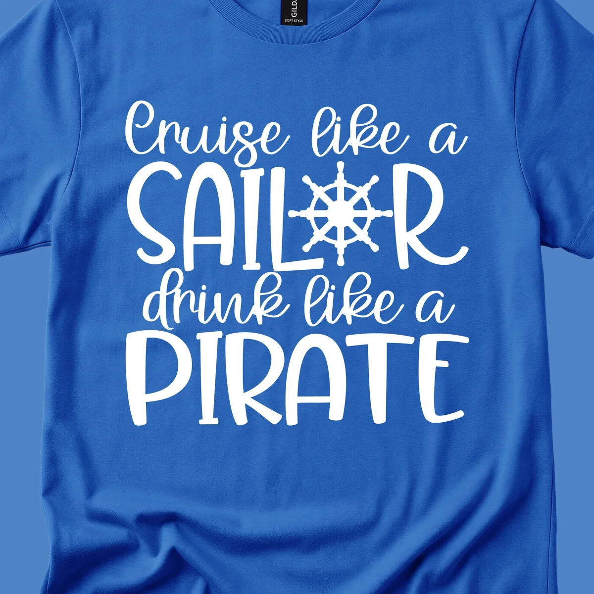 White text design with ship wheel graphic reading 'Cruise like a SAILOR drink like a PIRATE' on gray background