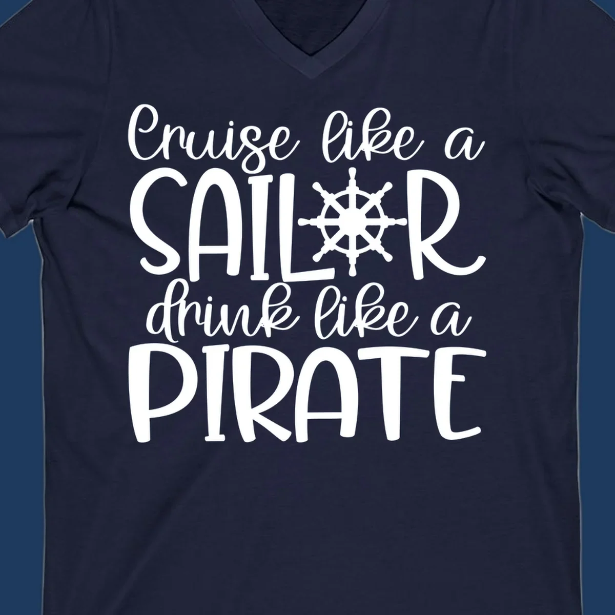 White text design with ship wheel graphic reading 'Cruise like a SAILOR drink like a PIRATE' on gray background
