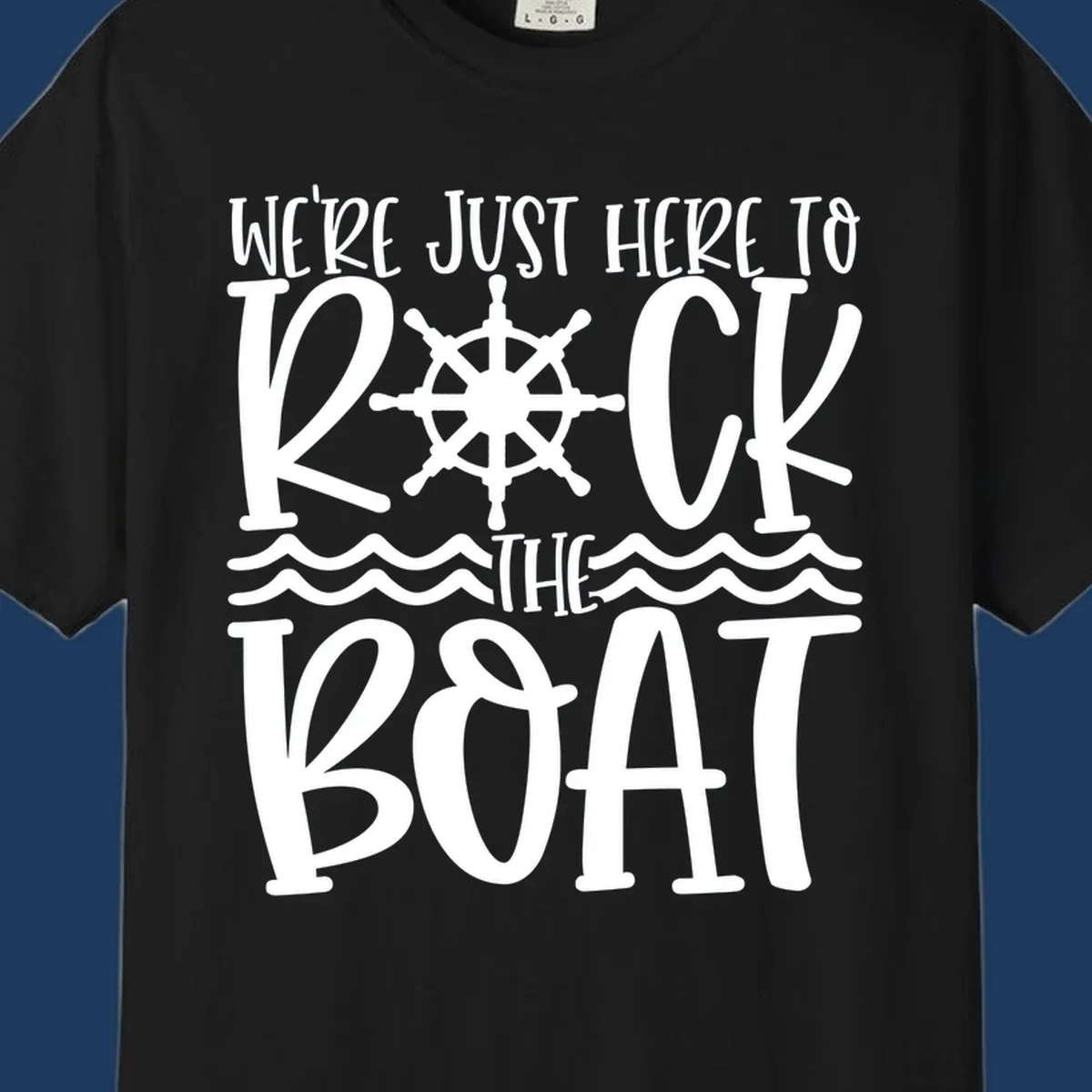 White nautical design with ship's wheel and ocean waves featuring text 'We're Just Here To Kick The Boat' on gray background