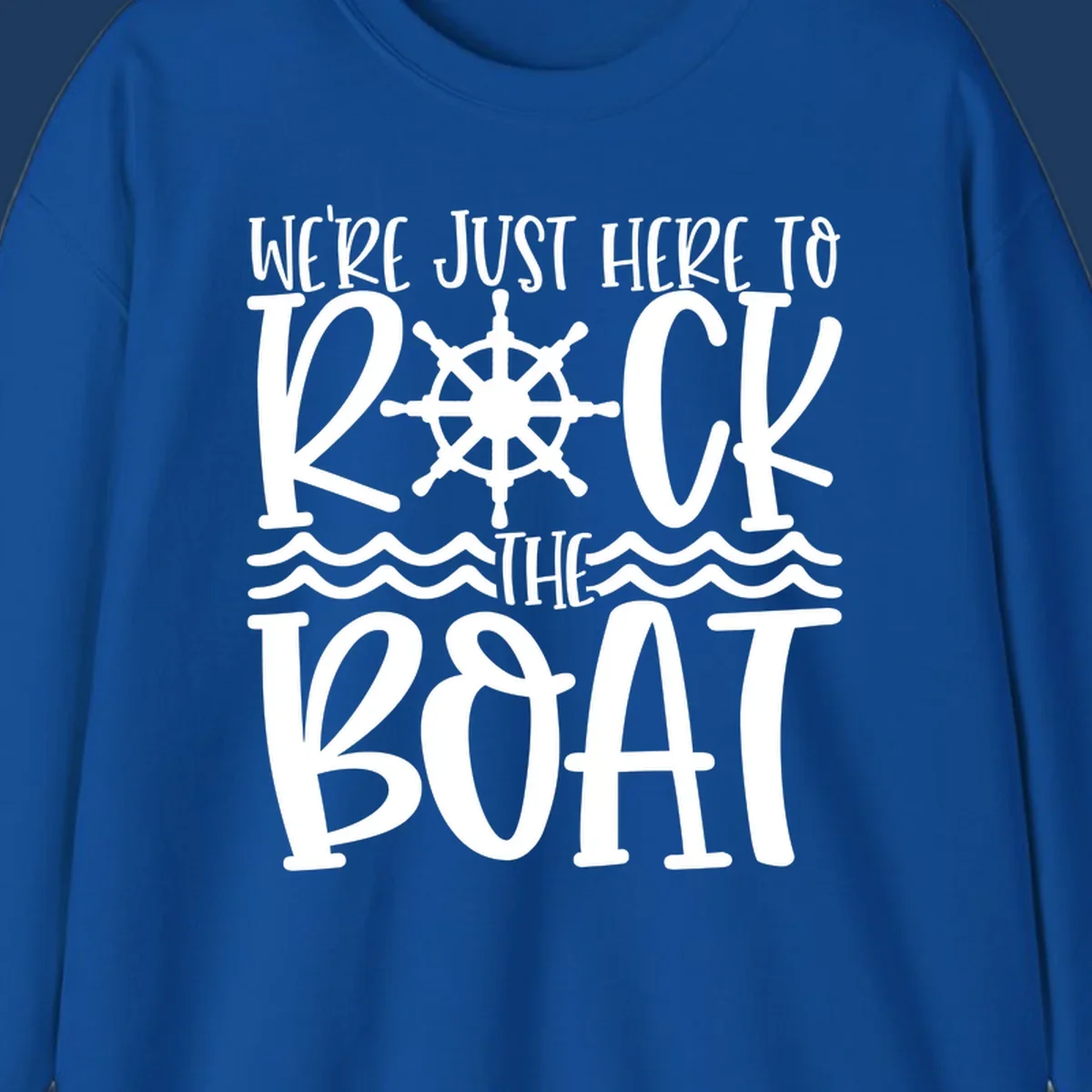 White nautical design with ship's wheel and ocean waves featuring text 'We're Just Here To Kick The Boat' on gray background