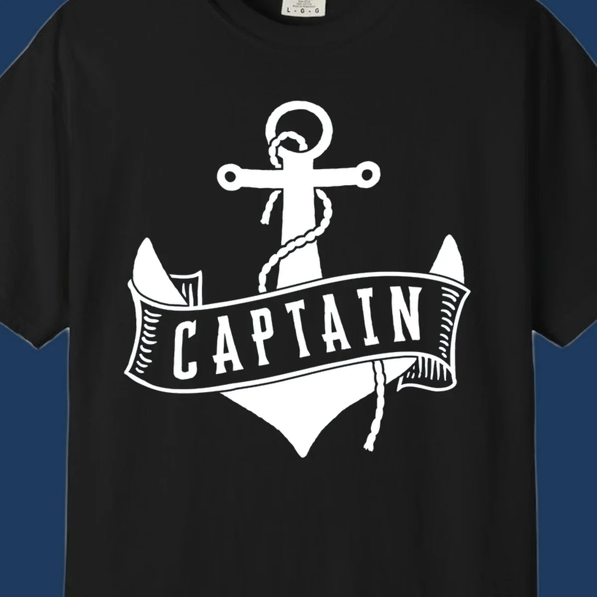 Vintage nautical captain anchor badge design with rope, cross emblem, sailing ship, and banner ribbon on gray background.