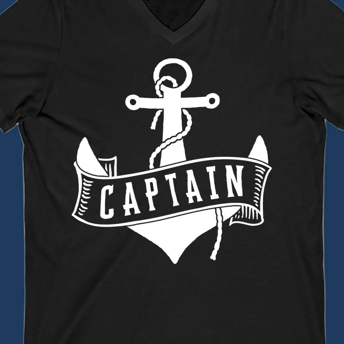 Vintage nautical captain anchor badge design with rope, cross emblem, sailing ship, and banner ribbon on gray background.