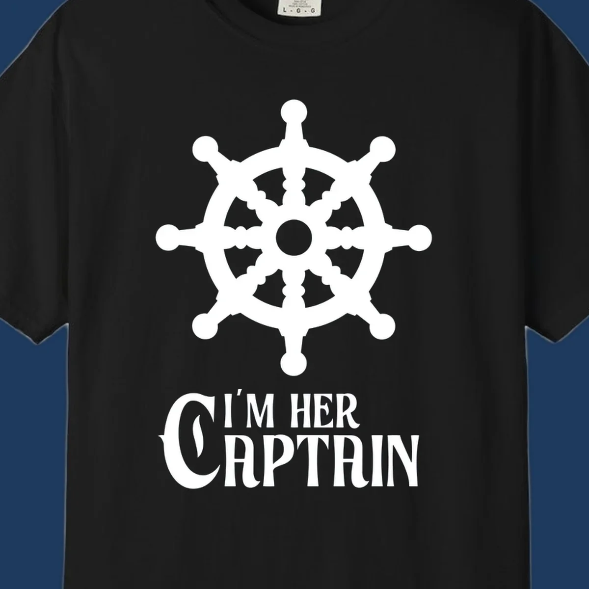 White ship's wheel with gray center above 'I'm Her Captain' text for cruise vacation apparel