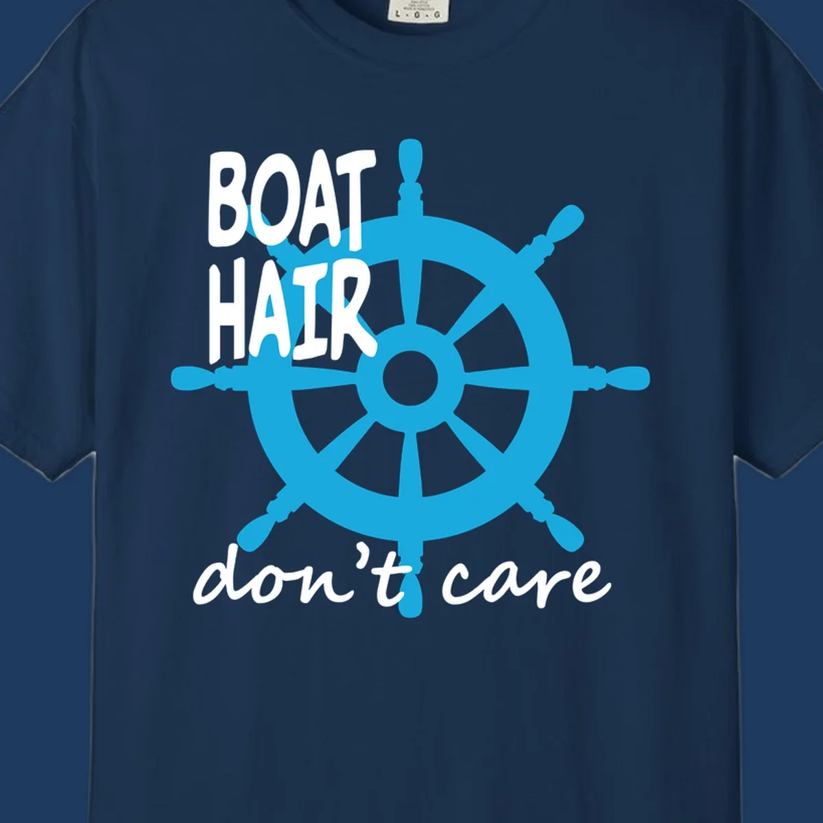 Blue ship's wheel graphic with white text reading 'BOAT HAIR don't care' - nautical cruise humor design