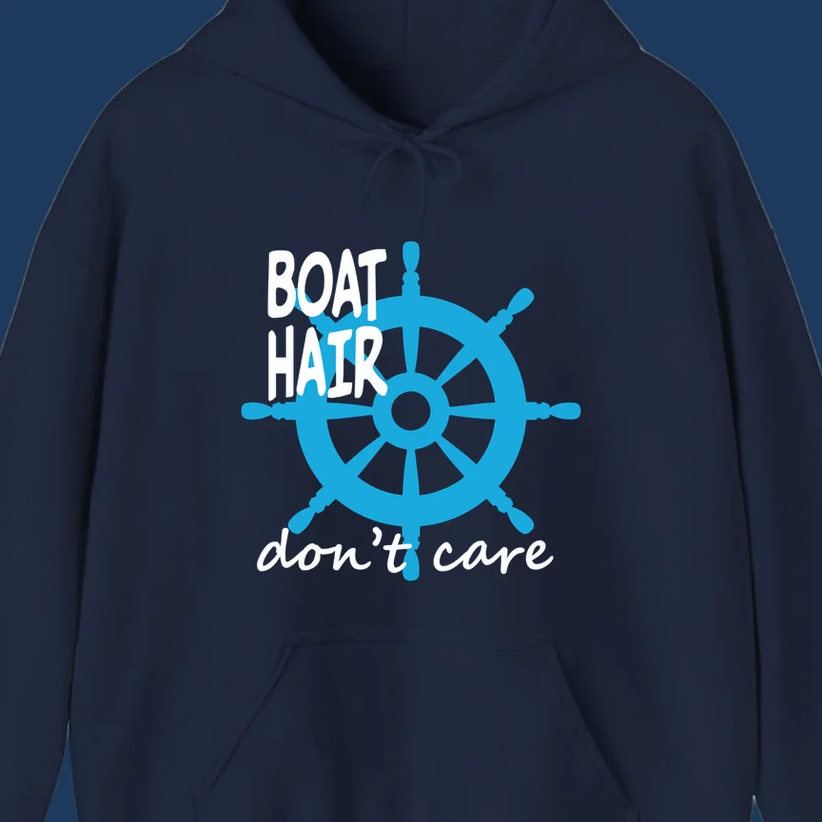 Blue ship's wheel graphic with white text reading 'BOAT HAIR don't care' - nautical cruise humor design