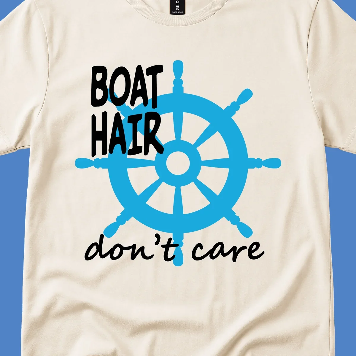 Blue ship's wheel graphic with white text reading 'BOAT HAIR don't care' - nautical cruise humor design