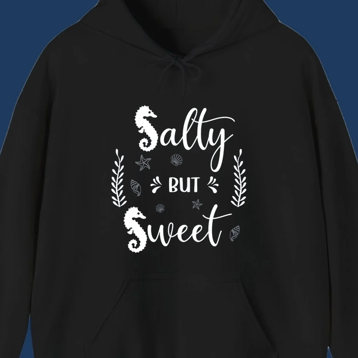 Salty but sweet nautical design with seahorses, starfish, and seashells in white on gray background