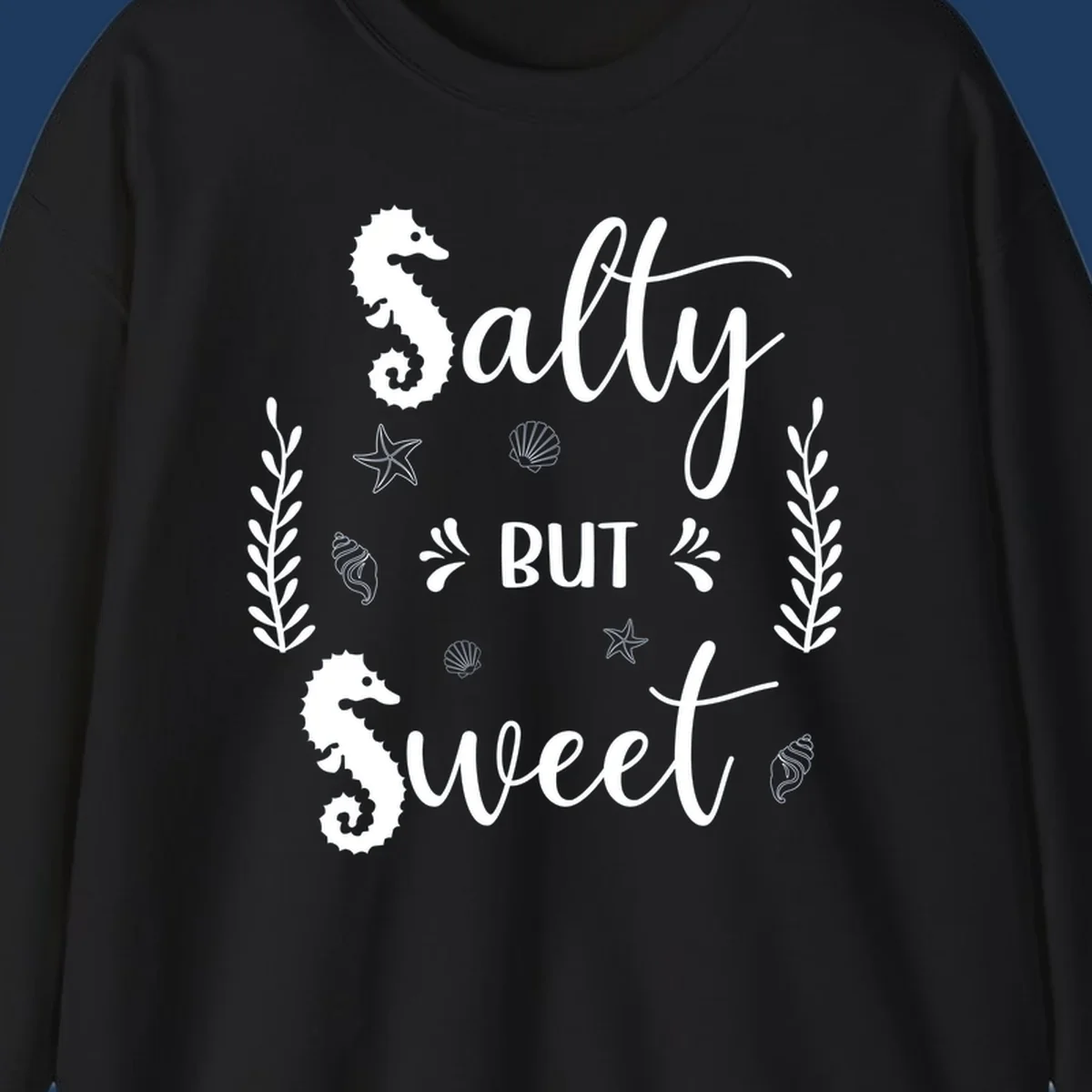 Salty but sweet nautical design with seahorses, starfish, and seashells in white on gray background