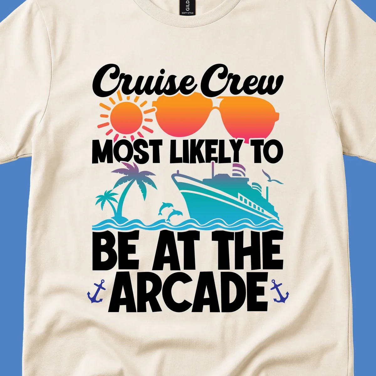 Colorful cruise-themed design with sun, sunglasses, palm tree, ship and waves. Text reads 'Cruise Crew Most Likely To Be At The Arcade' in white letters with gradient orange to teal colors and anchor accents.