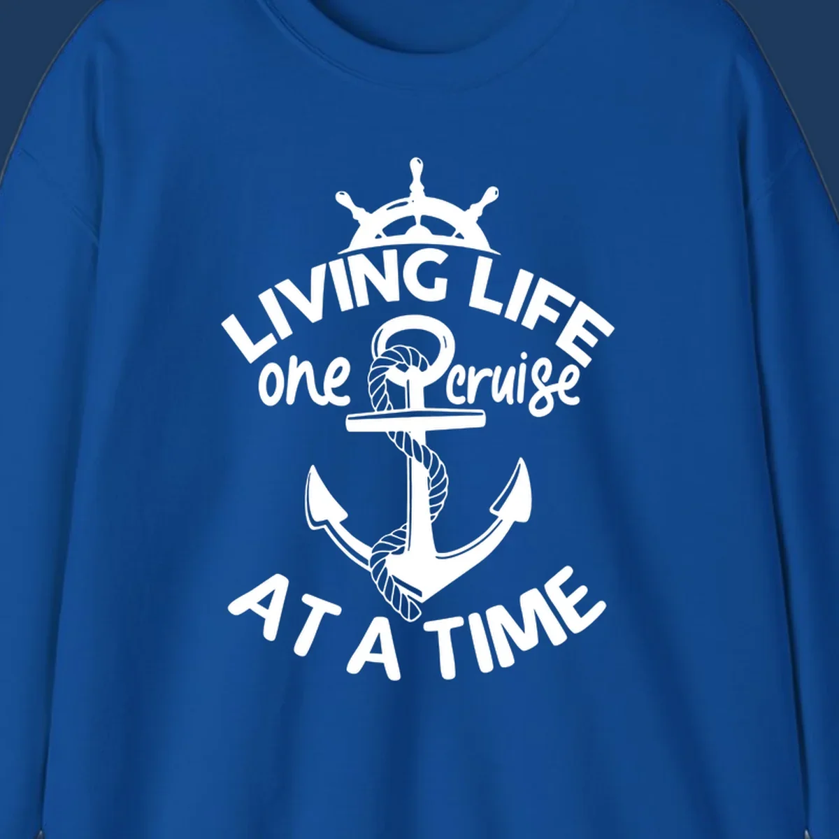 White nautical design with ship's wheel, anchor and rope on gray background with text living life one cruise at a time