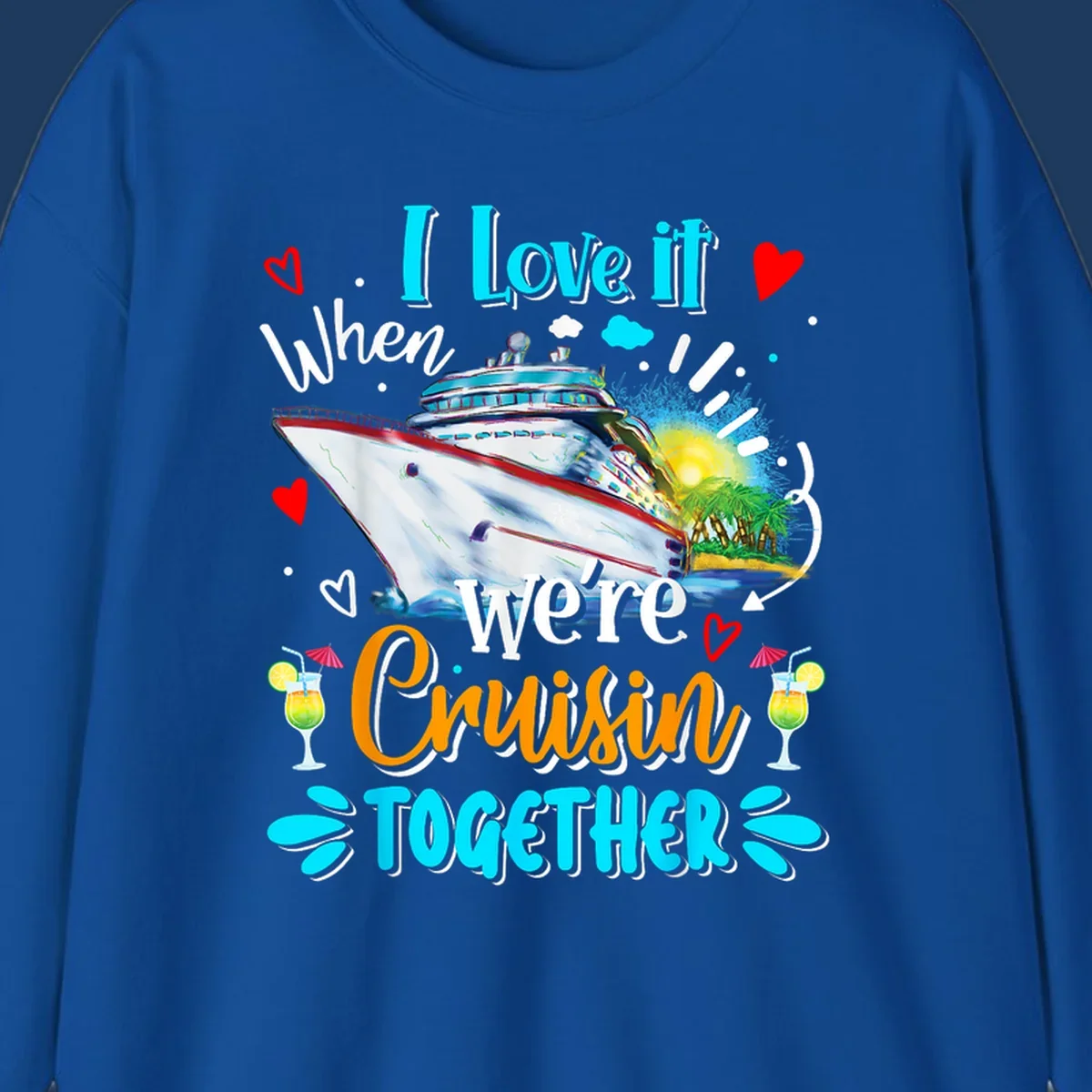 Colorful cruise ship with tropical island, hearts, and cocktails. Text reads 'I love it when we're Cruising Together' in cyan and orange lettering on gray background.