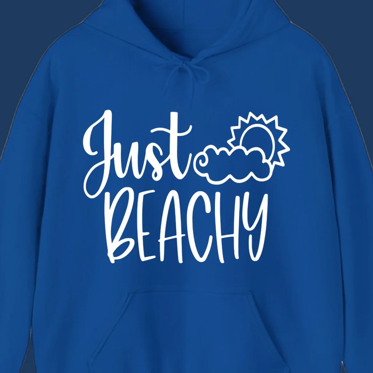 White illustrated text reading 'Just Beachy' with a smiling sun and cloud graphic, capturing beach vacation vibes