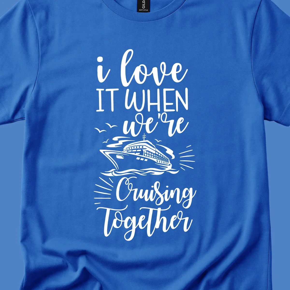 White script text reading 'i love it when we're cruising together' with an illustration of a cruise ship on ocean waves and seagulls
