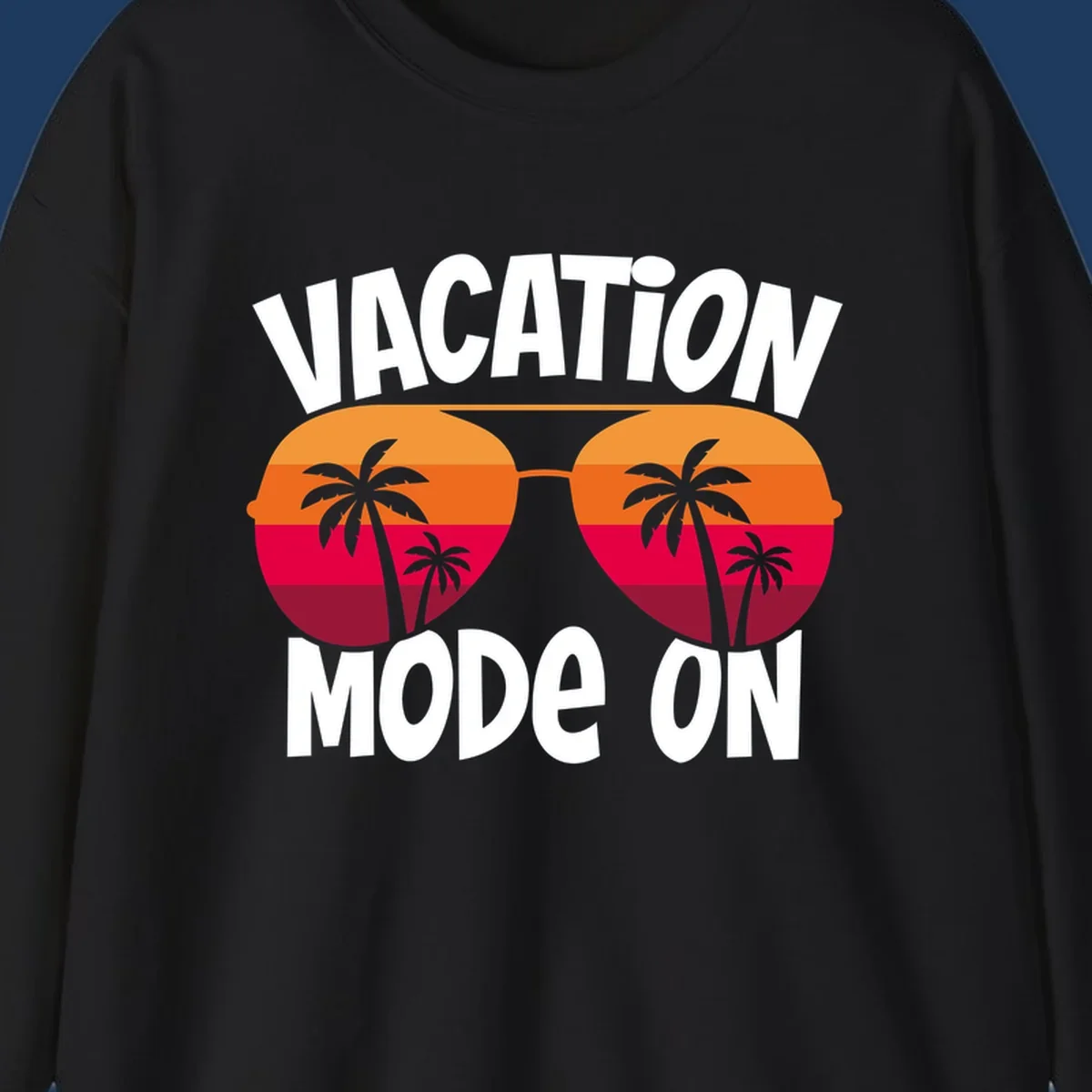 Vacation mode on design featuring oversized sunglasses with tropical sunset and palm trees inside each lens, framed by bold white text