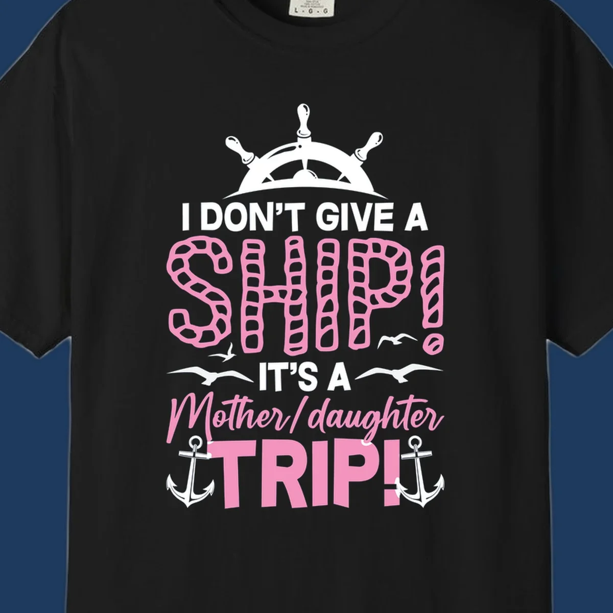 Gray design with ship wheel, anchors, and pink textured lettering reading 'I Don't Give A Ship It's A Mother Daughter Trip' - a nautical cruise humor design