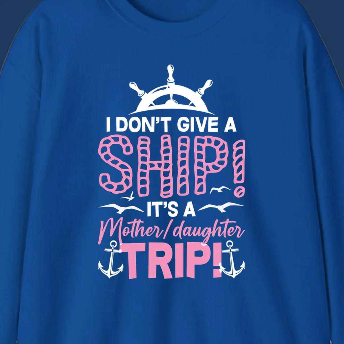 Gray design with ship wheel, anchors, and pink textured lettering reading 'I Don't Give A Ship It's A Mother Daughter Trip' - a nautical cruise humor design