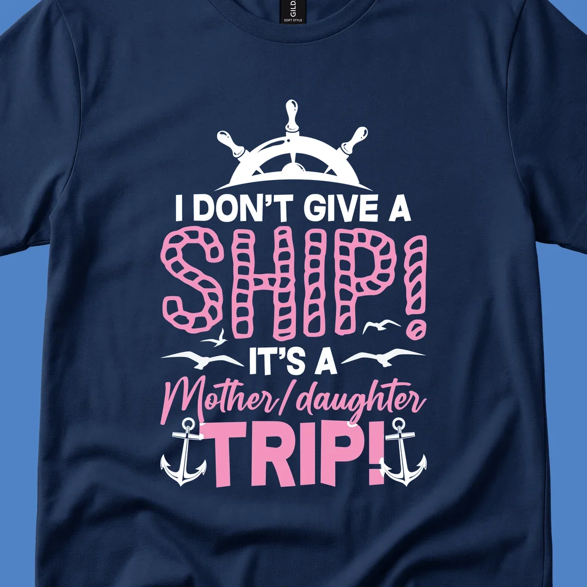 Gray design with ship wheel, anchors, and pink textured lettering reading 'I Don't Give A Ship It's A Mother Daughter Trip' - a nautical cruise humor design