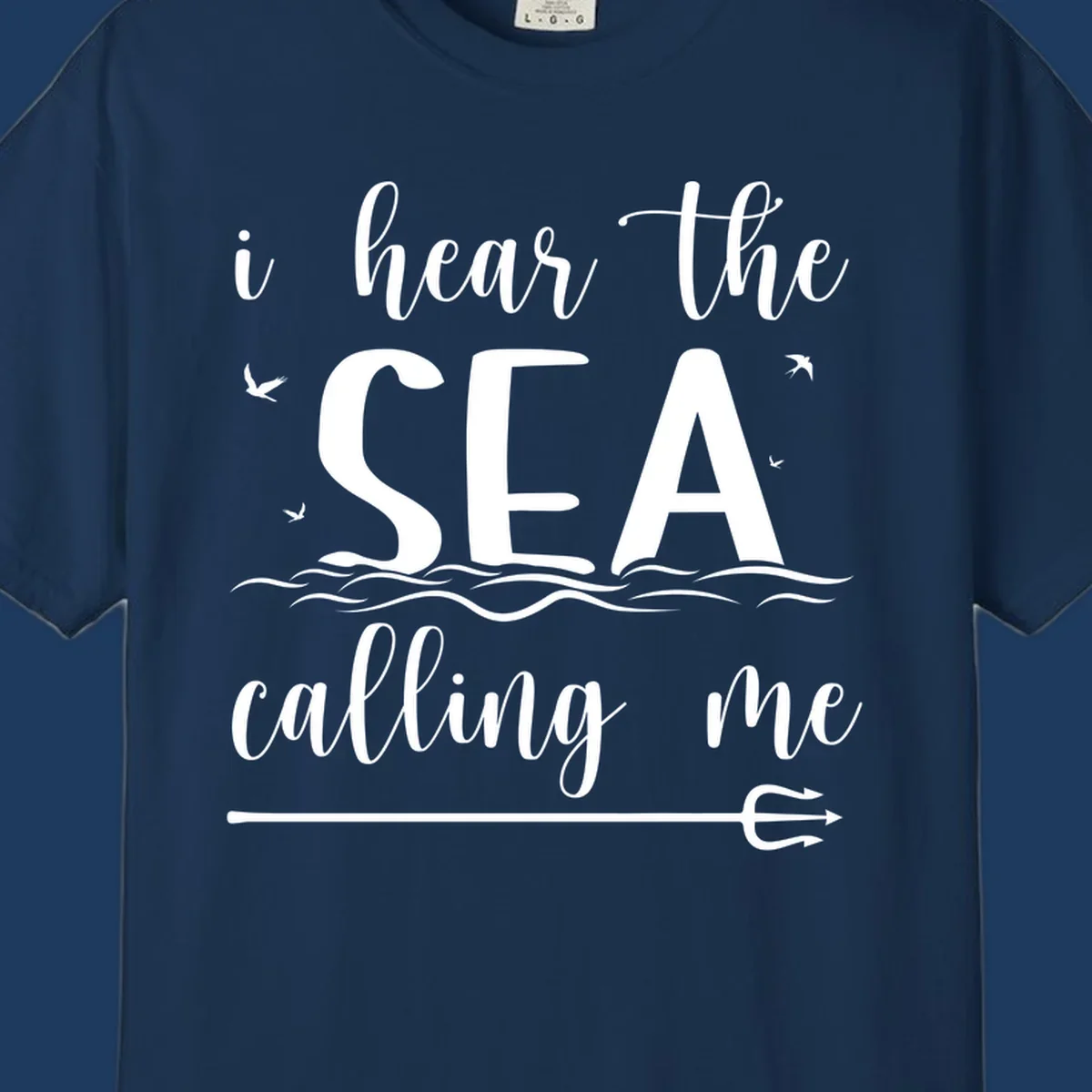 White nautical design with 'i hear the SEA calling me' text, ocean waves, seabirds, and trident anchor on gray background