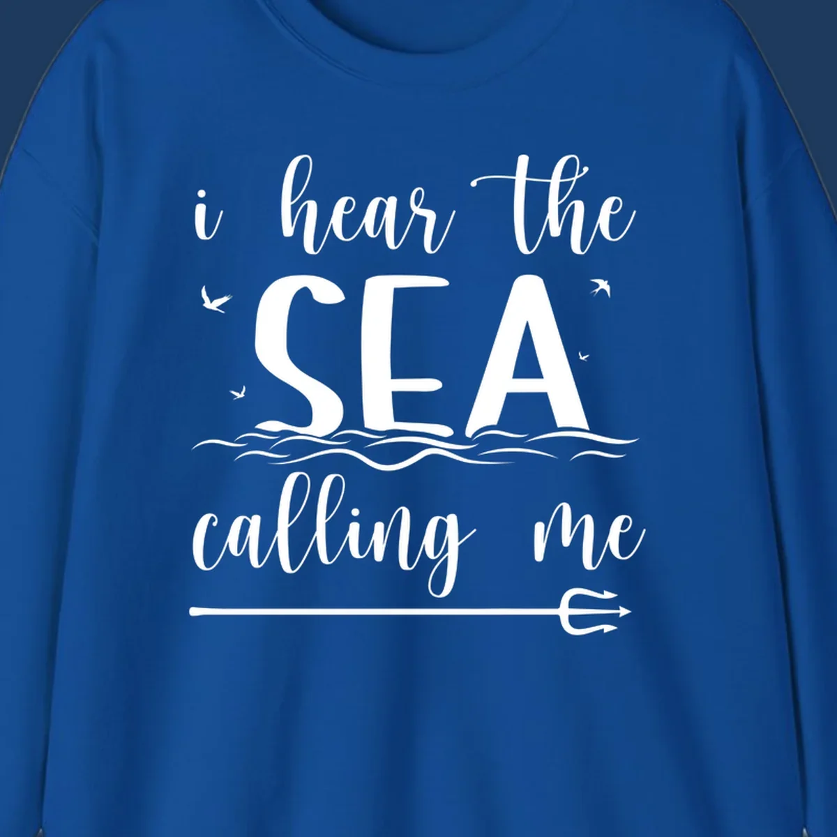White nautical design with 'i hear the SEA calling me' text, ocean waves, seabirds, and trident anchor on gray background