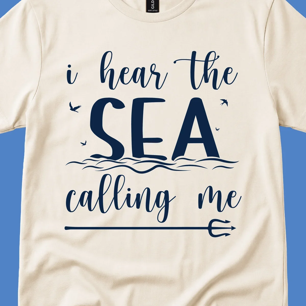White nautical design with 'i hear the SEA calling me' text, ocean waves, seabirds, and trident anchor on gray background