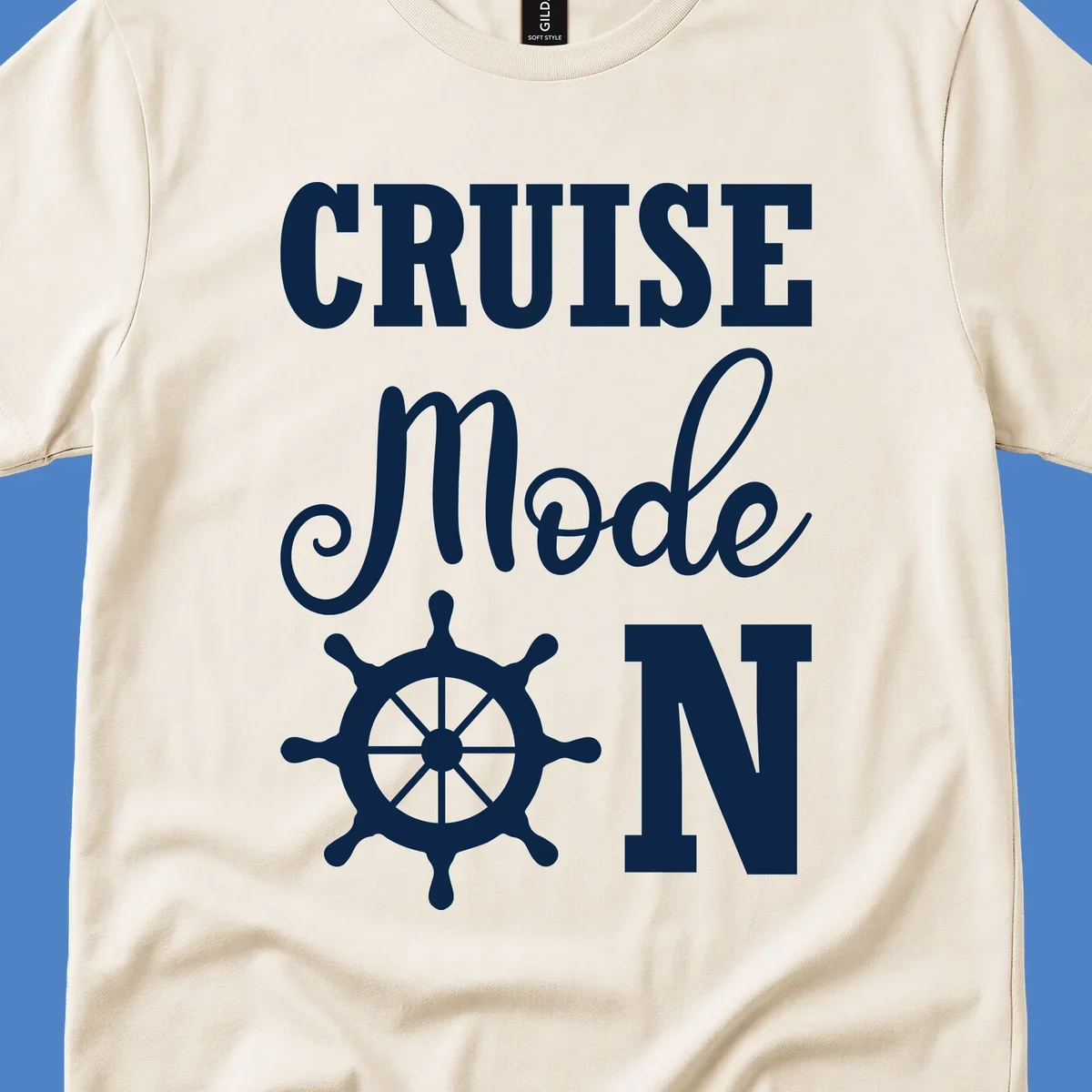 White ship wheel with cruise mode text design on gray background for nautical vacation apparel