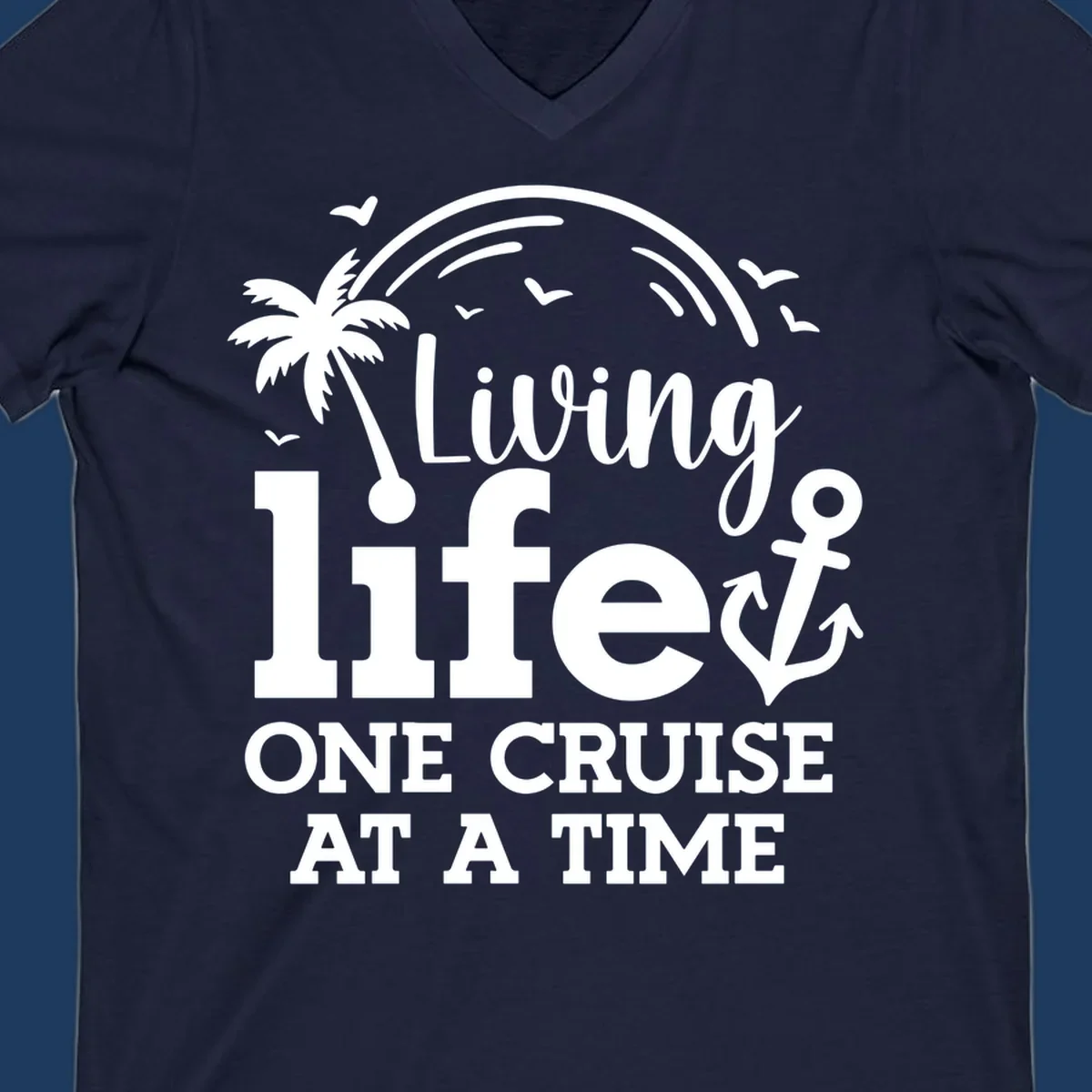 White tropical design with palm tree, anchor, rainbow and seagulls surrounding text 'Living life ONE CRUISE AT A TIME' on gray background