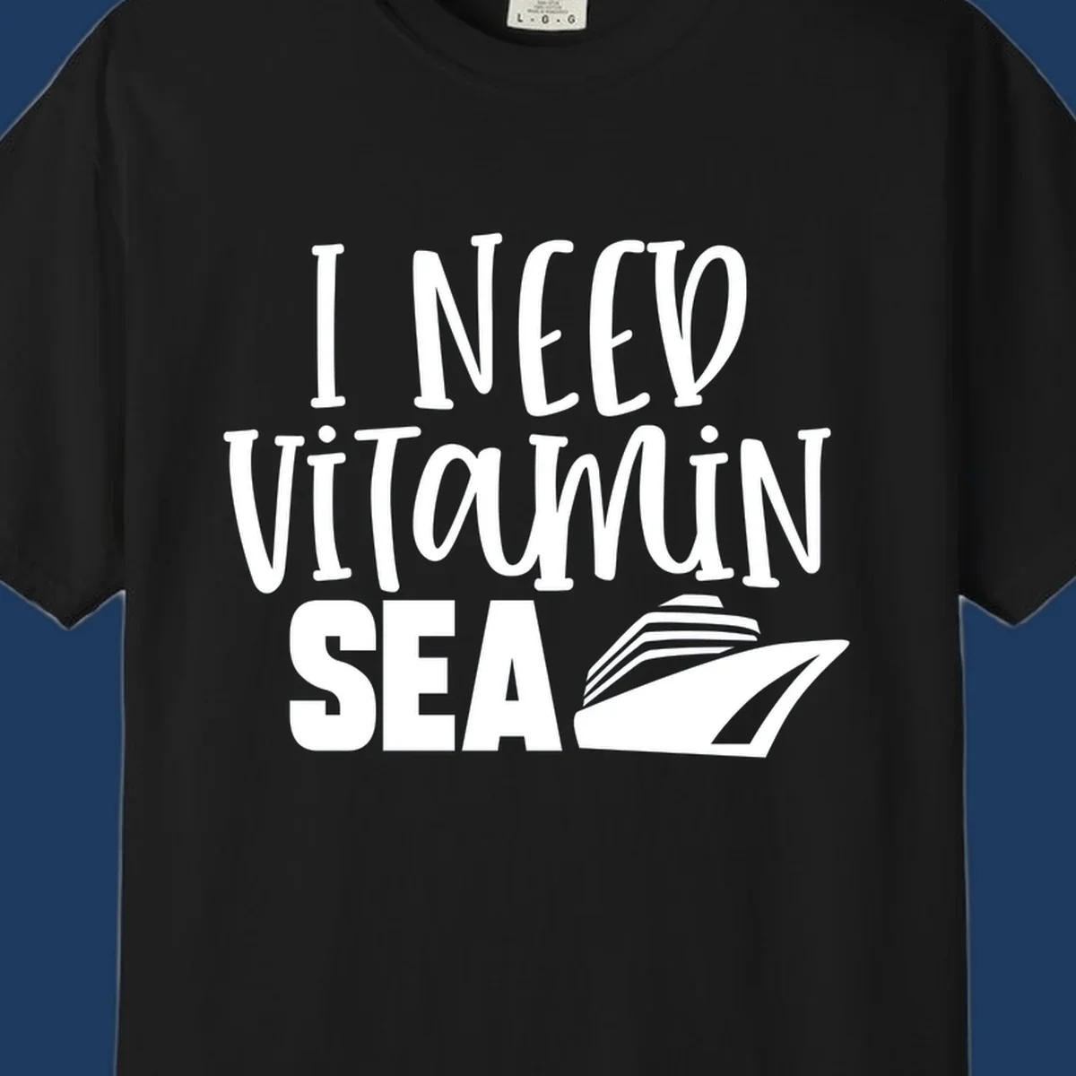 White text reading 'I Need Vitamin Sea' with a stylized cruise ship illustration on gray background