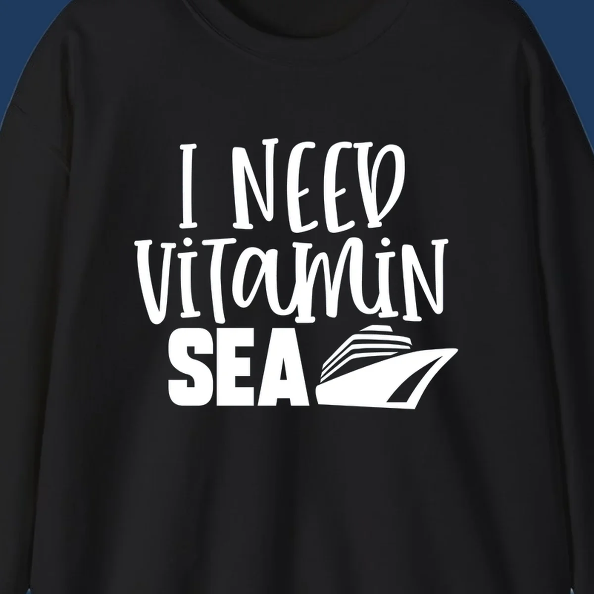 White text reading 'I Need Vitamin Sea' with a stylized cruise ship illustration on gray background