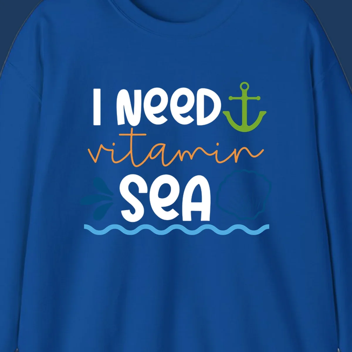 Nautical design with white text reading 'I Need Vitamin Sea' surrounded by anchor, shells, waves, and water droplets in orange, green, and blue