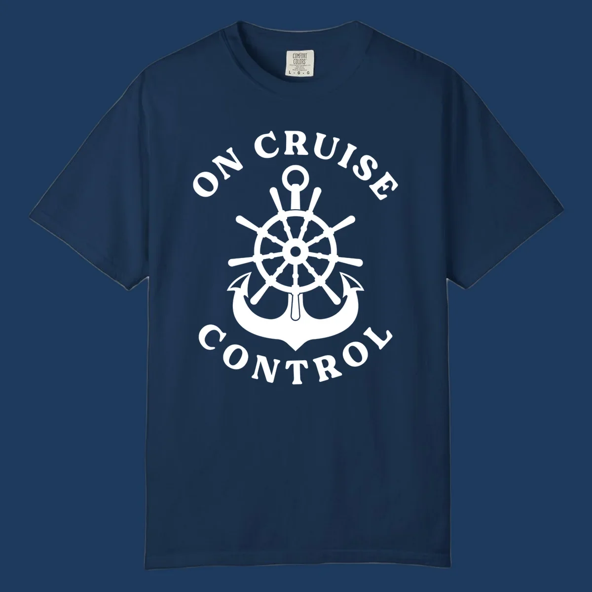 On cruise control nautical badge with ship wheel, anchors, crown and shield design in white on gray background.
