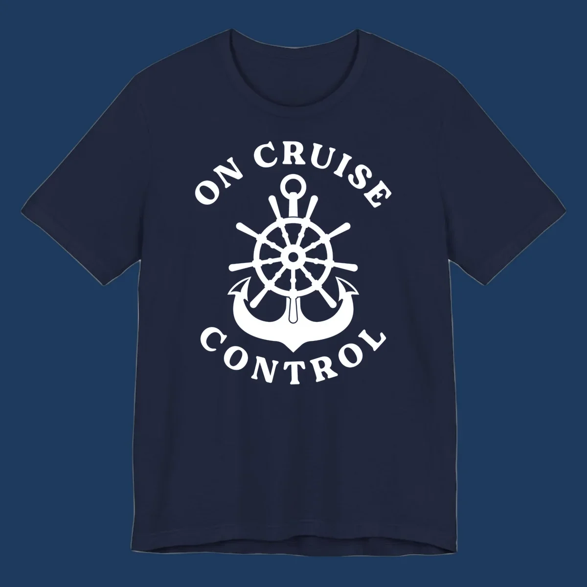 On cruise control nautical badge with ship wheel, anchors, crown and shield design in white on gray background.