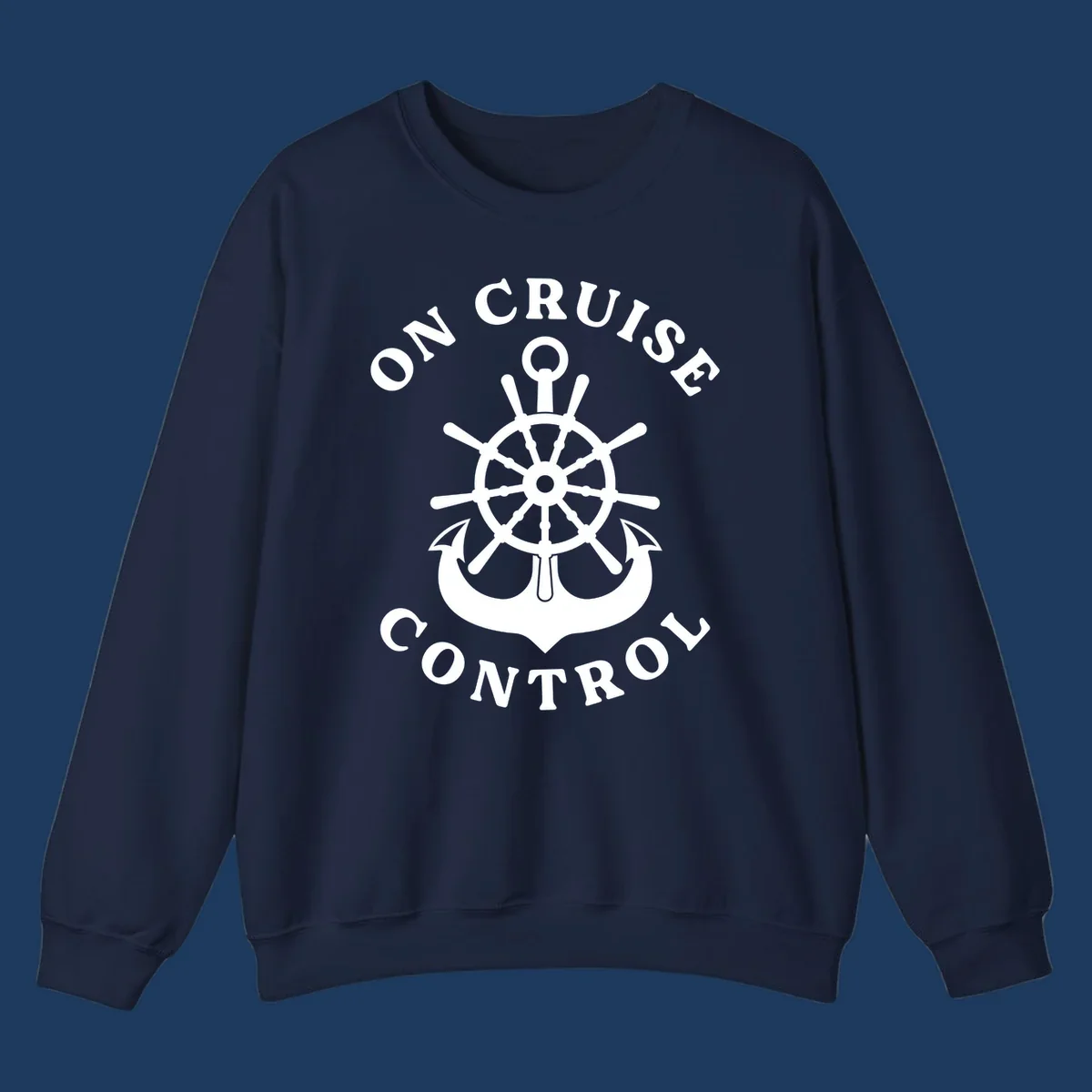 On cruise control nautical badge with ship wheel, anchors, crown and shield design in white on gray background.