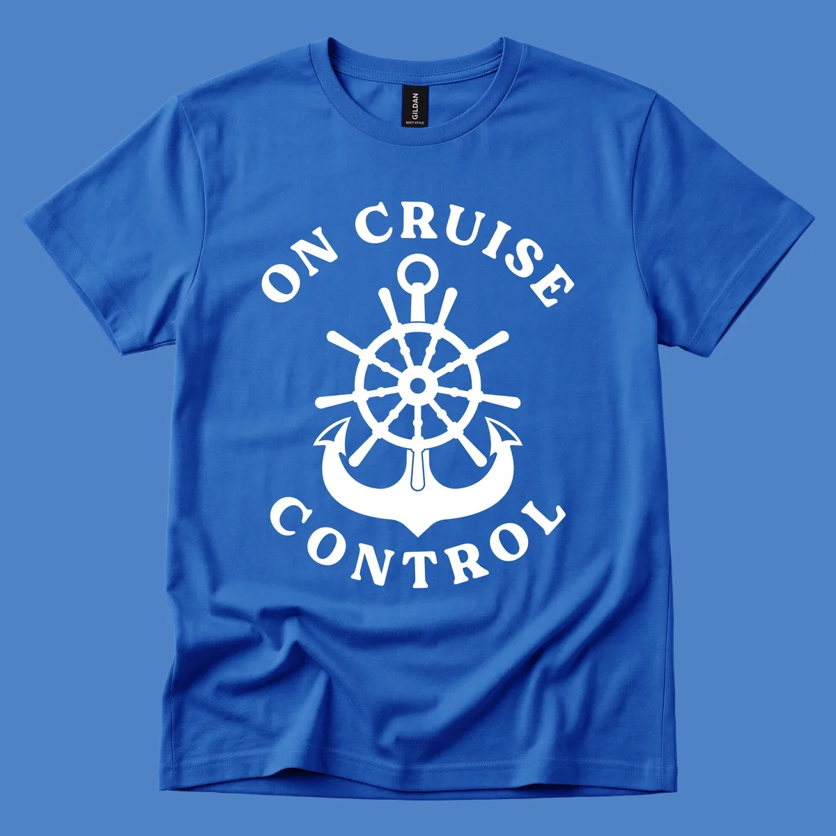 On cruise control nautical badge with ship wheel, anchors, crown and shield design in white on gray background.