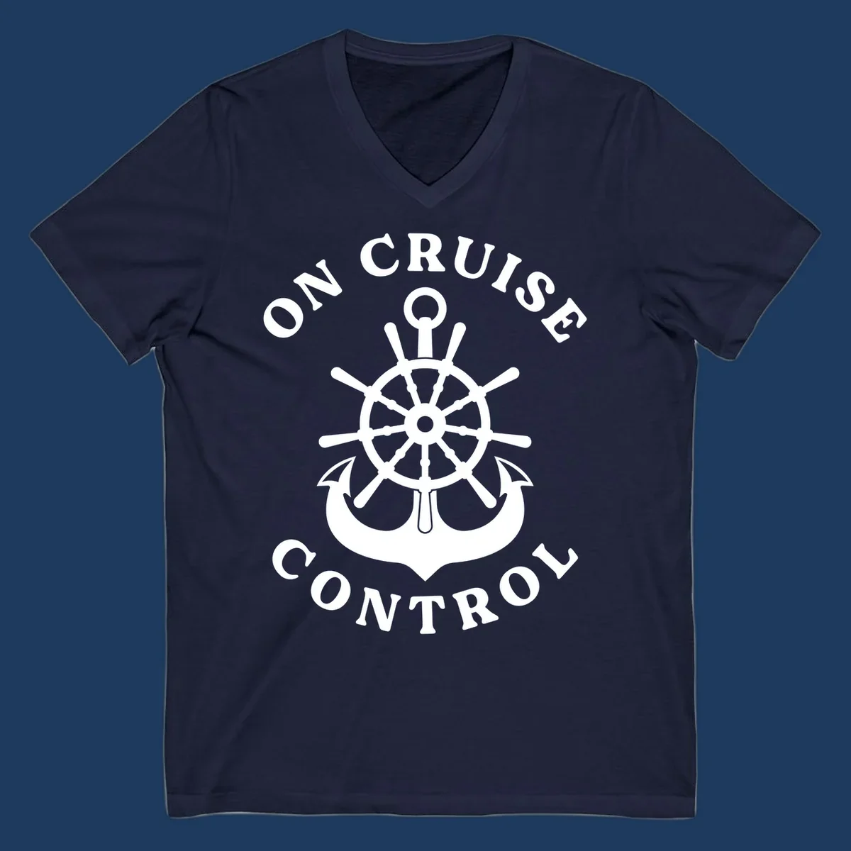 On cruise control nautical badge with ship wheel, anchors, crown and shield design in white on gray background.