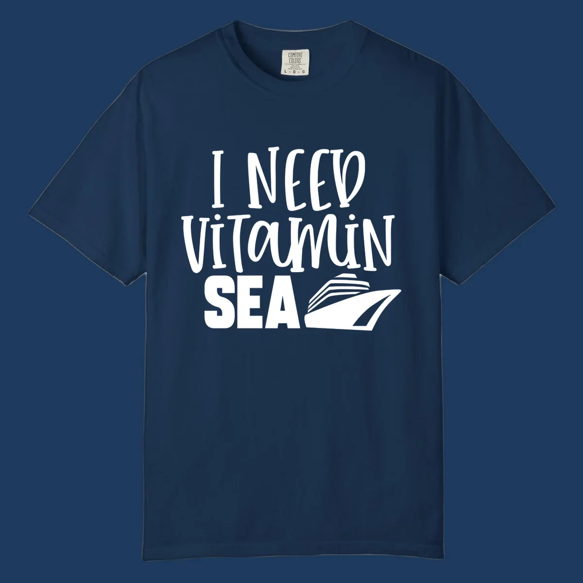 White text reading 'I NEED VITAMIN SEA' with a cruise ship illustration on gray background