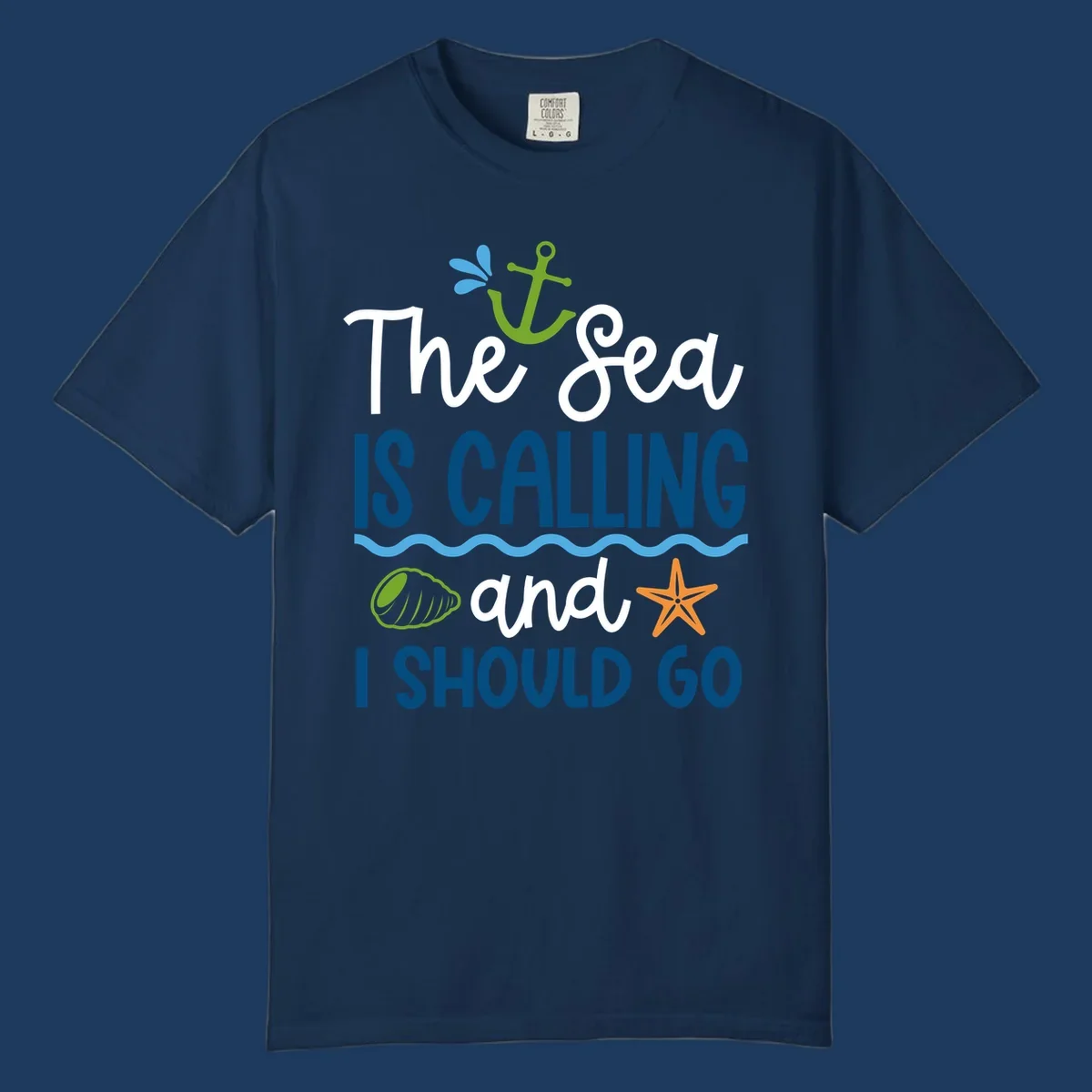 Gray tee design with 'The Sea Is Calling and I Should Go' text in white and blue, decorated with nautical icons including anchor, starfish, seashell, and ocean waves.